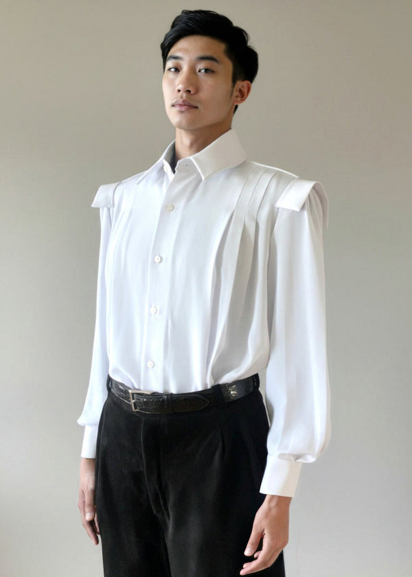 The Stacy Stewart Smith Poet Laureate Poet Laureate — a generously cut silk dress shirt with soft pleats, full-tucked sleeves, a crisp convertible collar with detachable neck jabot, and a samurai-inspired Kataginu shoulder. Romantic, dapper, and deliberately oversized in drape on a mannequin 6'3" with Stacy Stewart Smith onyx pigskin suede pleated Windsor pants and an alligator belt against a neutral background.