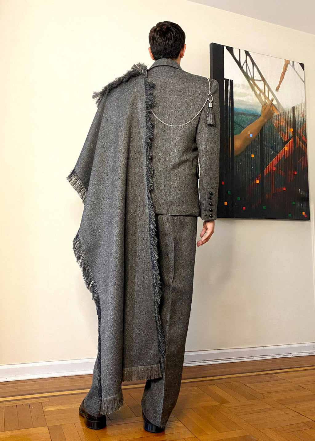 Stacy Stewart Smith Men's Diamond Dodger Tailored 3-Piece Tweed Suit on a mannequin 6'3" back view in a room with an antique white wall, wooden floor and oil painting by the designer.