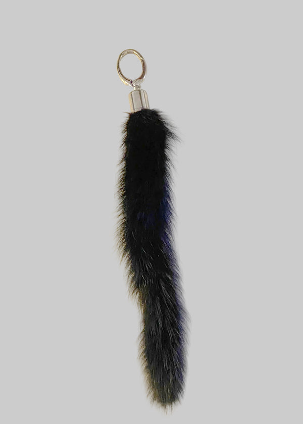 Black Gamma mink tail chrome topped keyring by Stacy Stewart Smith on an antique white surface