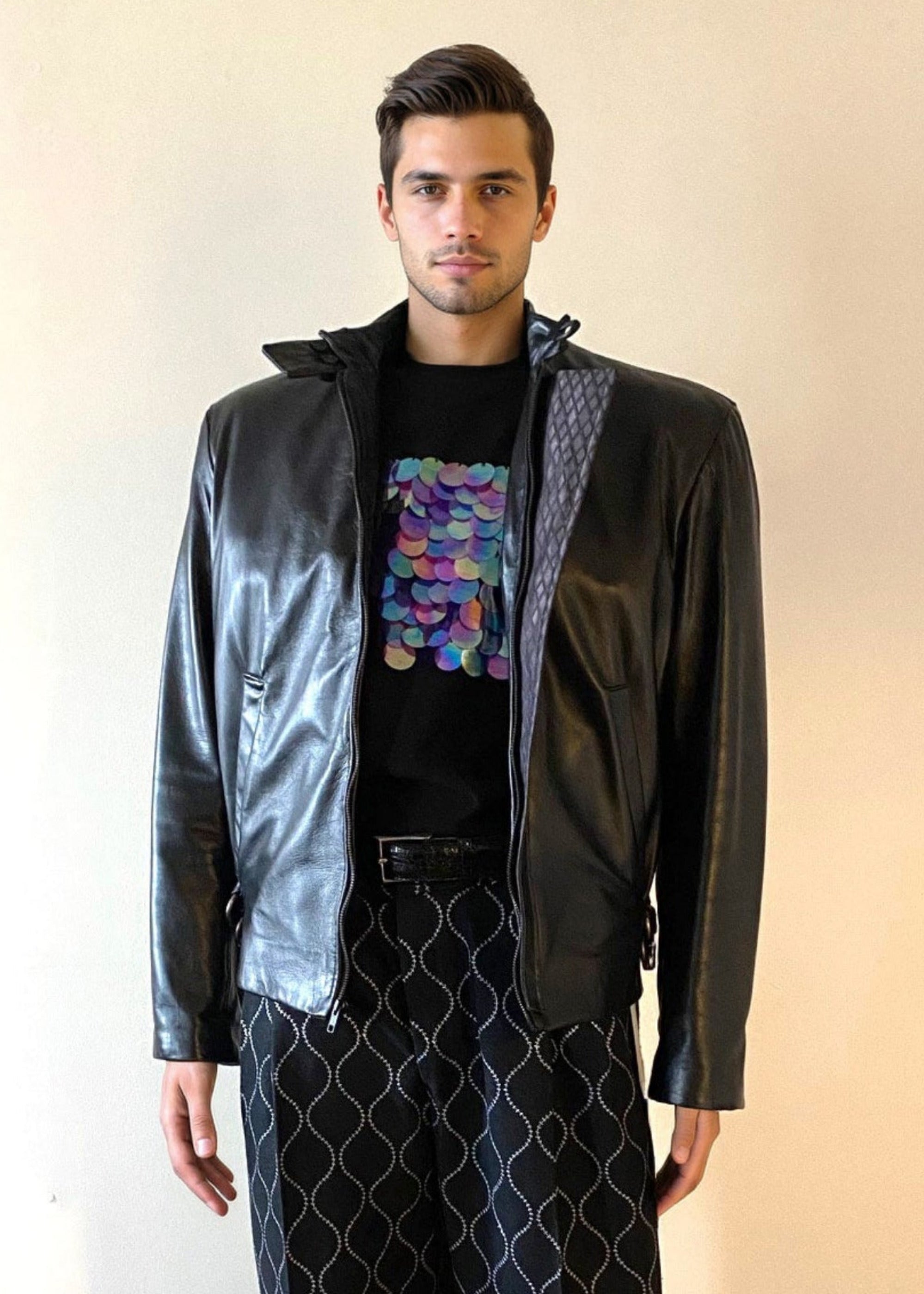 Stacy Stewart Smith Men's Flange-Back Leather Moto Jacket  on a mannequin 6'3" front view with jacket open with Dragon Scales T-shirt and Ogee embroidered raw silk Windsor pants all all by the designer.