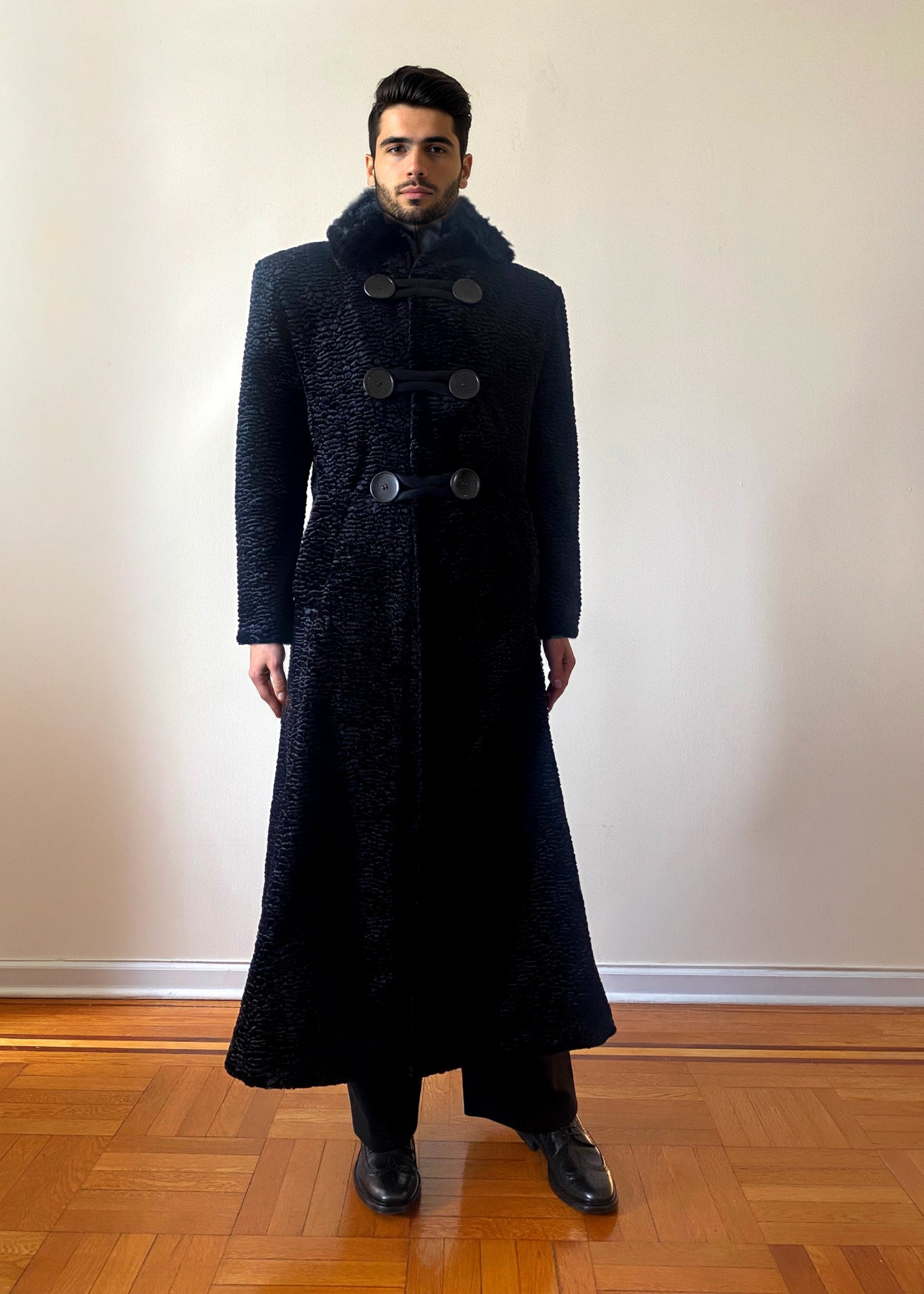 Stacy Stewart Smith Night Watchman Faux Persian Lamb Coat in Coal Black, shown on a mannequin at 6'3