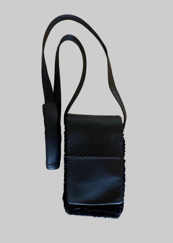 Stacy Stewart Smith Onyx Persian lamb and leather Pocket Messenger  bag with a strap on a gray background