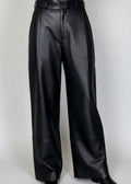 Stacy Stewart Smith Men's Onyx Leather Pleated Windsor Pants on mannequin 6'3" 3/4 full frontal view in black cowboy boots with gray backdrop 