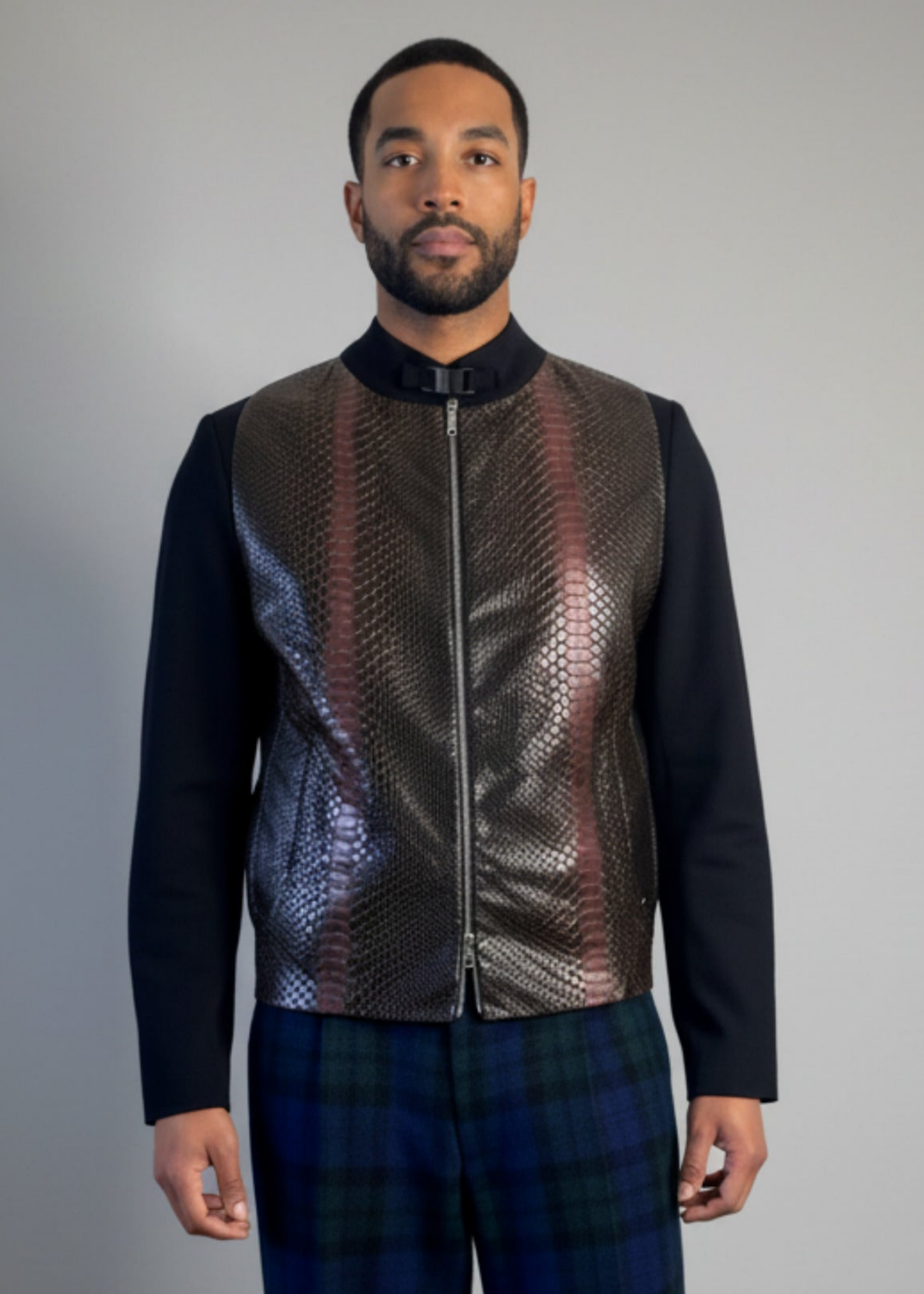 cropped front view of Stacy Stewart Smith's Python & Denim Bellhop Jacket with Blackwatch Plaid Harris Tweed Reality Pants on male model 6'3" against a plain gray backdrop