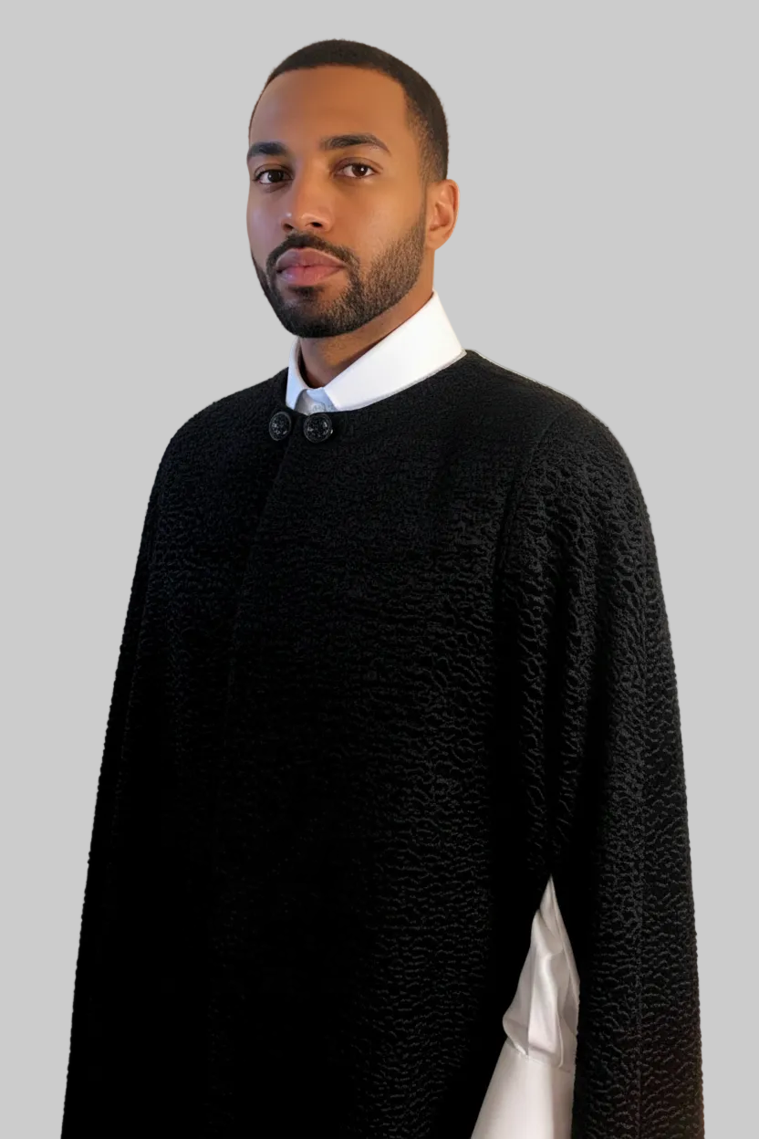 The Grand Soir Palace Cape by Stacy  Stewart Smith in black Persian lamb on a mannequin 6'3" against a light gray backdrop. Front view zoomed-in with  cape closed to show  front without bugle beading, but with ornate double glass button closure and one arm through front elbow slit. 