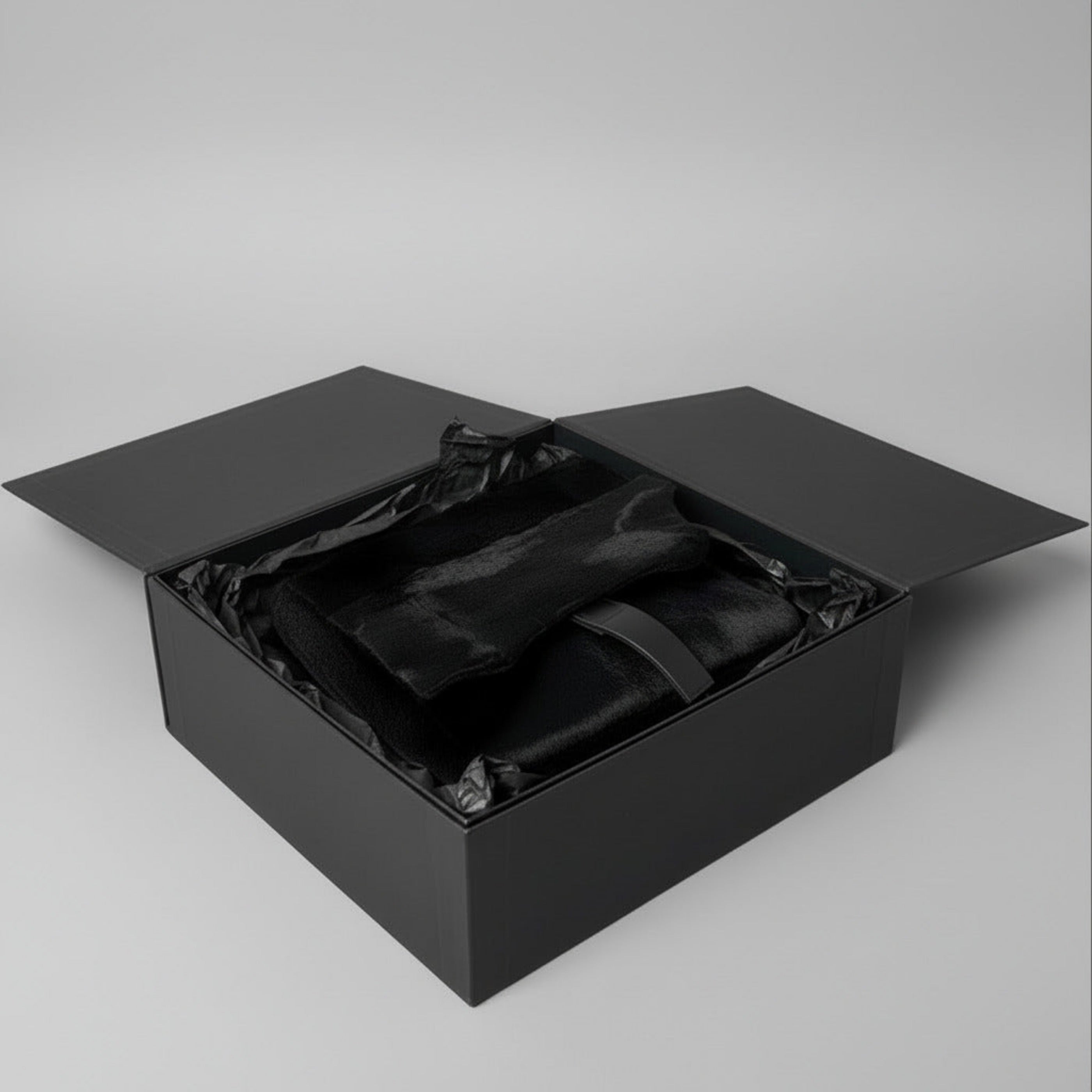 Stacy Stewart Smith Hair-On Calf Powder Satchel Bag front view in a black gift box with black tissue paper on a  gray background. 