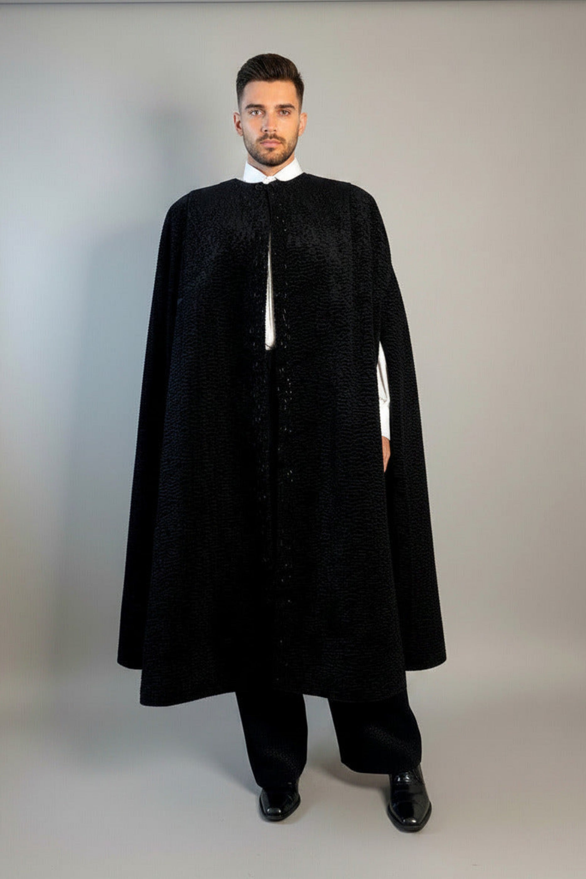The Grand Soir Palace Cape by Stacy  Stewart Smith is cut for exactly that moment — a structured sweep of flowing black Persian lamb on a mannequin 6'3" against a gray backdrop. Front view with  cape slightly open to show bugle beading and one arm through front elbow slit.