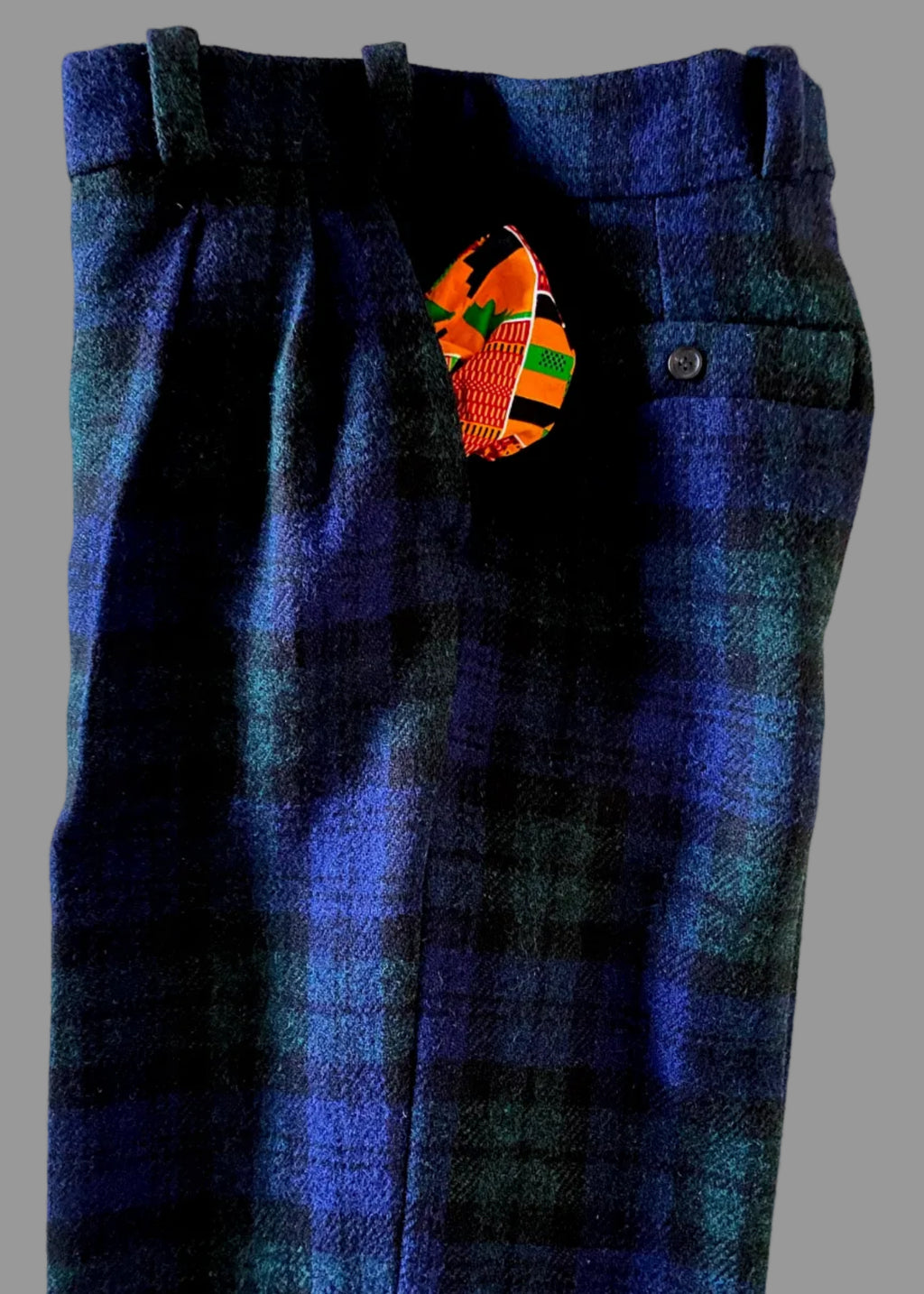 Stacy Stewart Smith's Blackwatch Plaid Harris Tweed® Reality Pants with the Kente cloth pocketing pulled out.