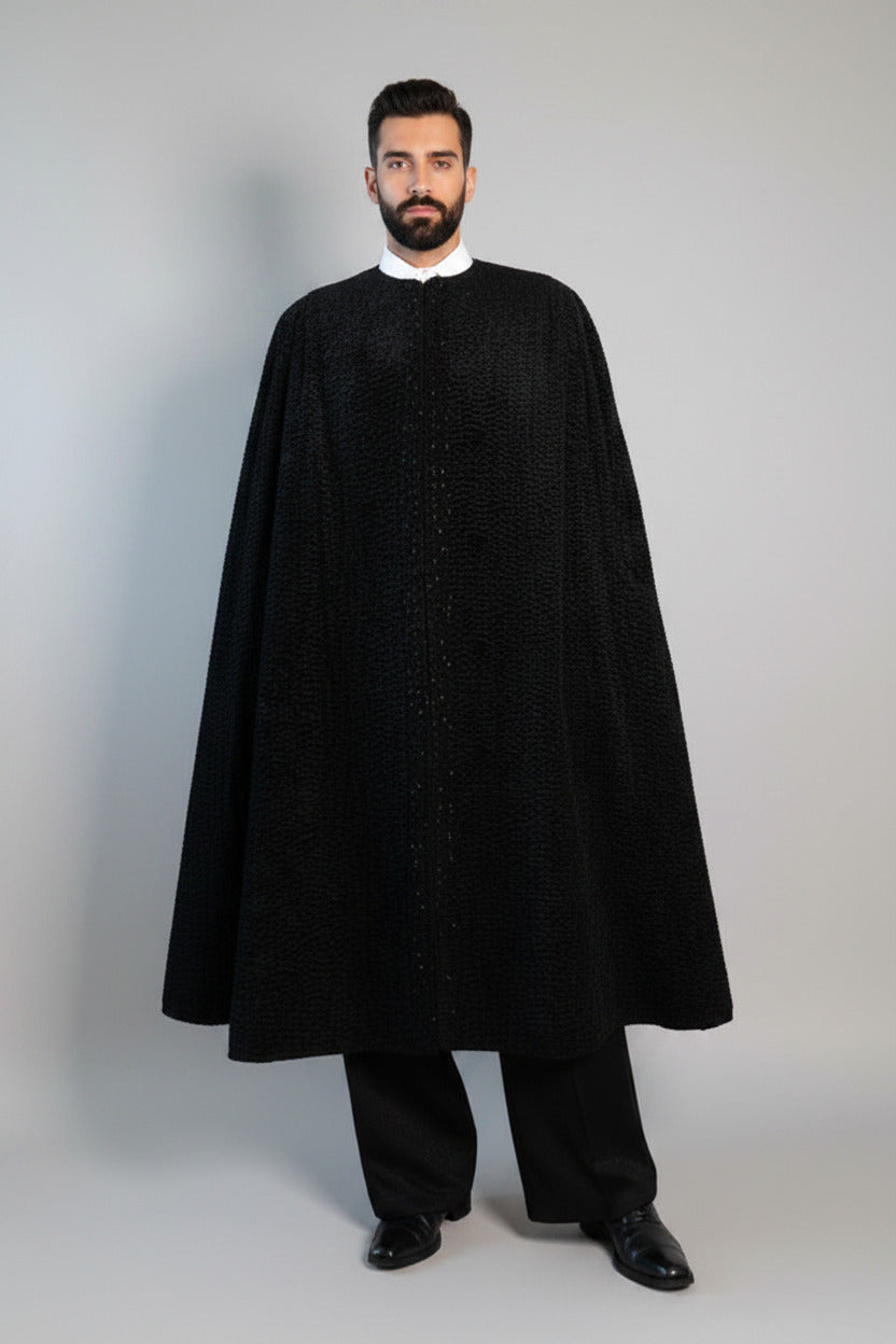 The Grand Soir Palace Cape by Stacy  Stewart Smith is cut for exactly that moment — a structured sweep of flowing black Persian lamb on a mannequin 6'3" against a gray backdrop. Front view with cape closed showing beaded front.