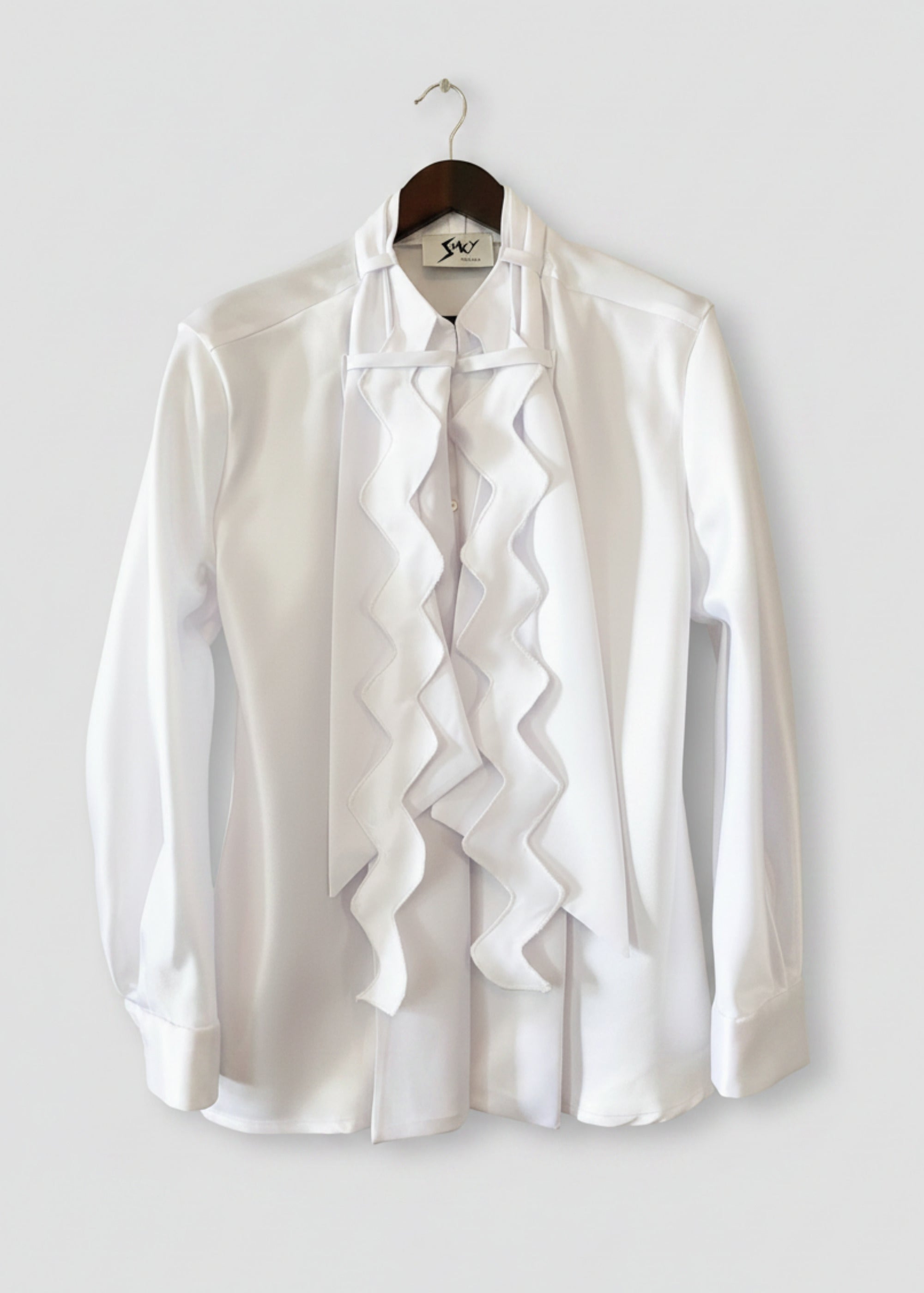 Stacy Stewart Smith Men's Noble Innocent Satin Shirt on a hanger front view against antique white wall.