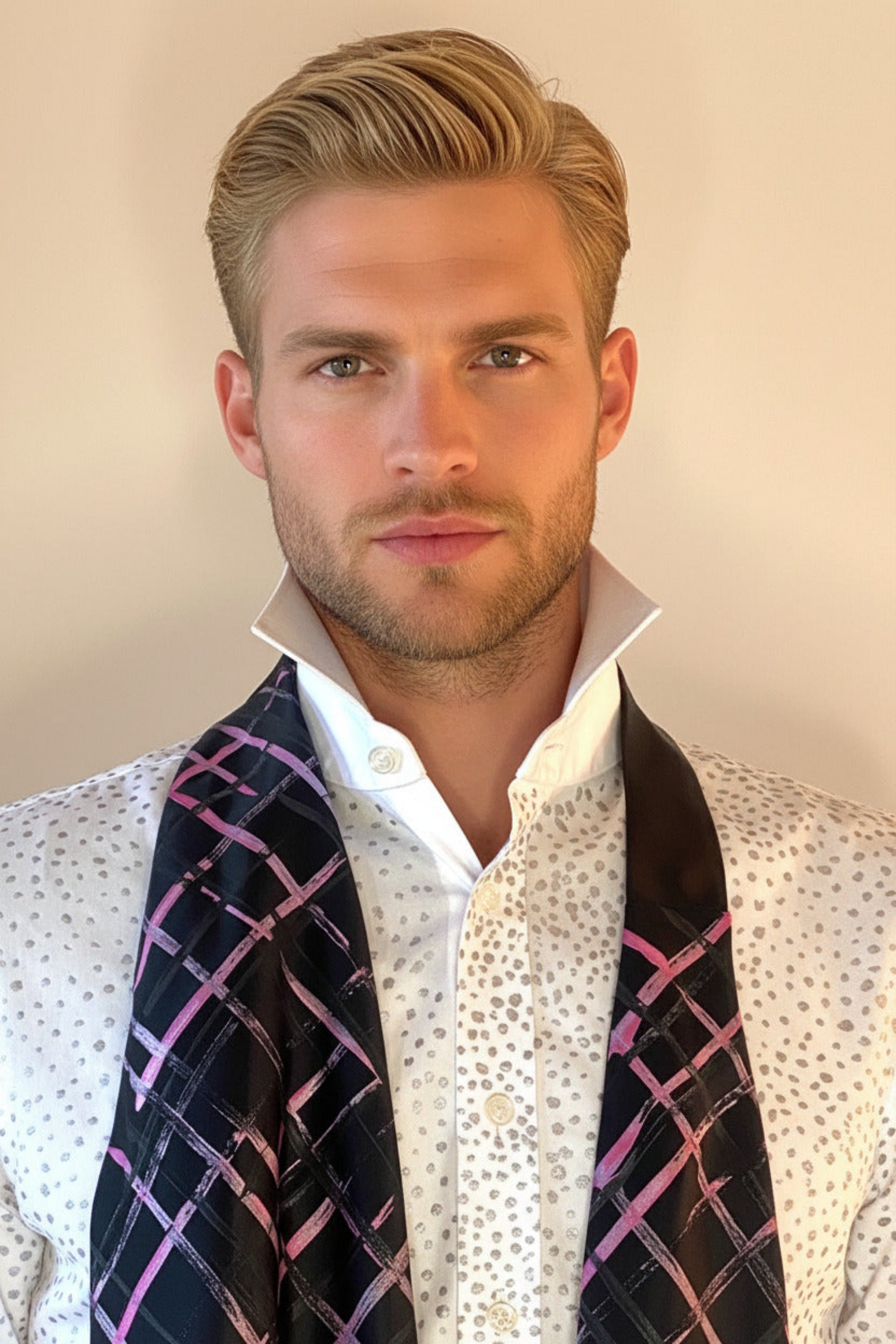HOW TO TIE A CRAVAT: STEP 2 Atelier Quarterly presents Stacy Stewart Smith's Hand-Painted Cotton Percale Shirt and Hand-Painted Silk Cravat in Onyx/Shocking on a male mannequin front view with collar up against an ivory backdrop.