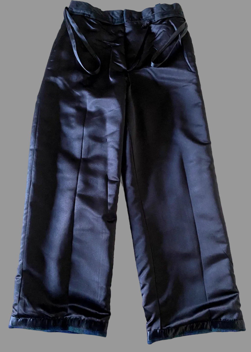 Front inside lining of Stacy Stewart Smith's Blackwatch Plaid Harris Tweed® Reality Pants against a gray background.
