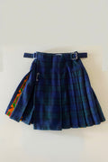 Stacy  Stewart Smith men's Harris Tweed© Blackwatch in blue and green tones Plaid reality Kilt has Kente cloth inlays, chrome side adjustable buckles and kilt flat against a plain light surface.