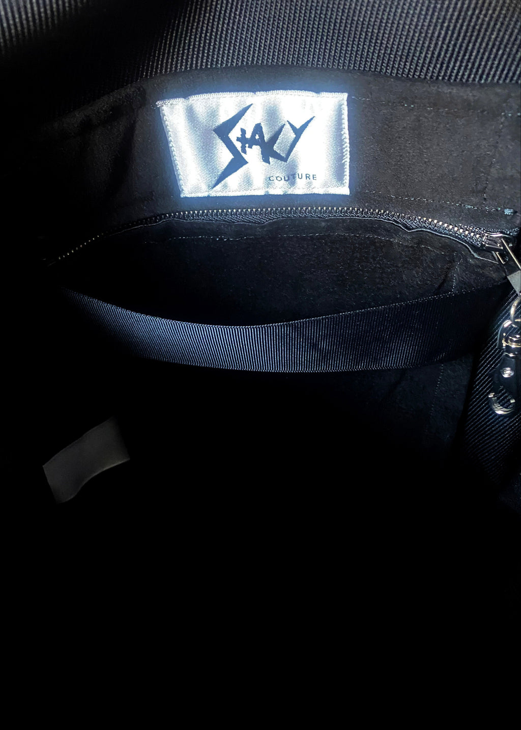 Stacy Stewart Smith Hair-On Calf Powder Satchel Bag zoomed inside lining front view of brand label and zip pocket.