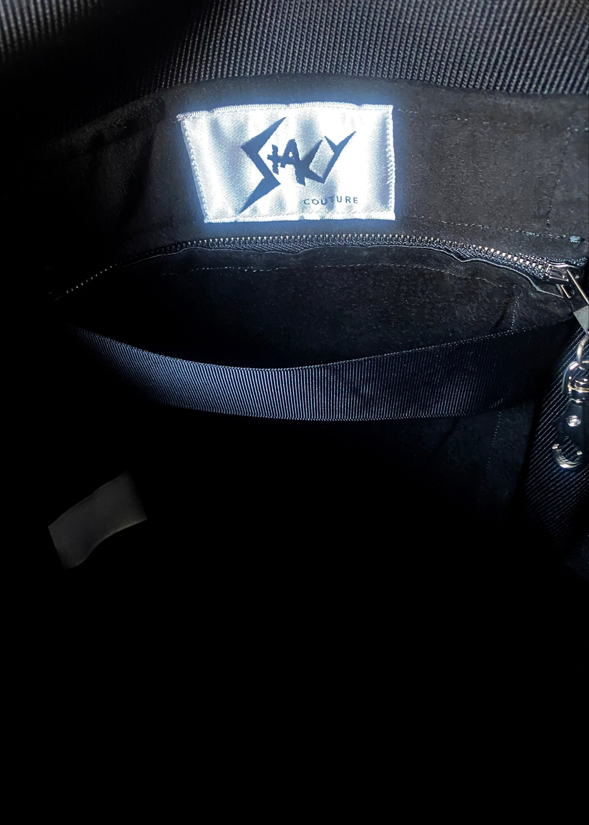 Stacy Stewart Smith Hair-On Calf Powder Satchel Bag zoomed inside lining front view of brand label and zip pocket.