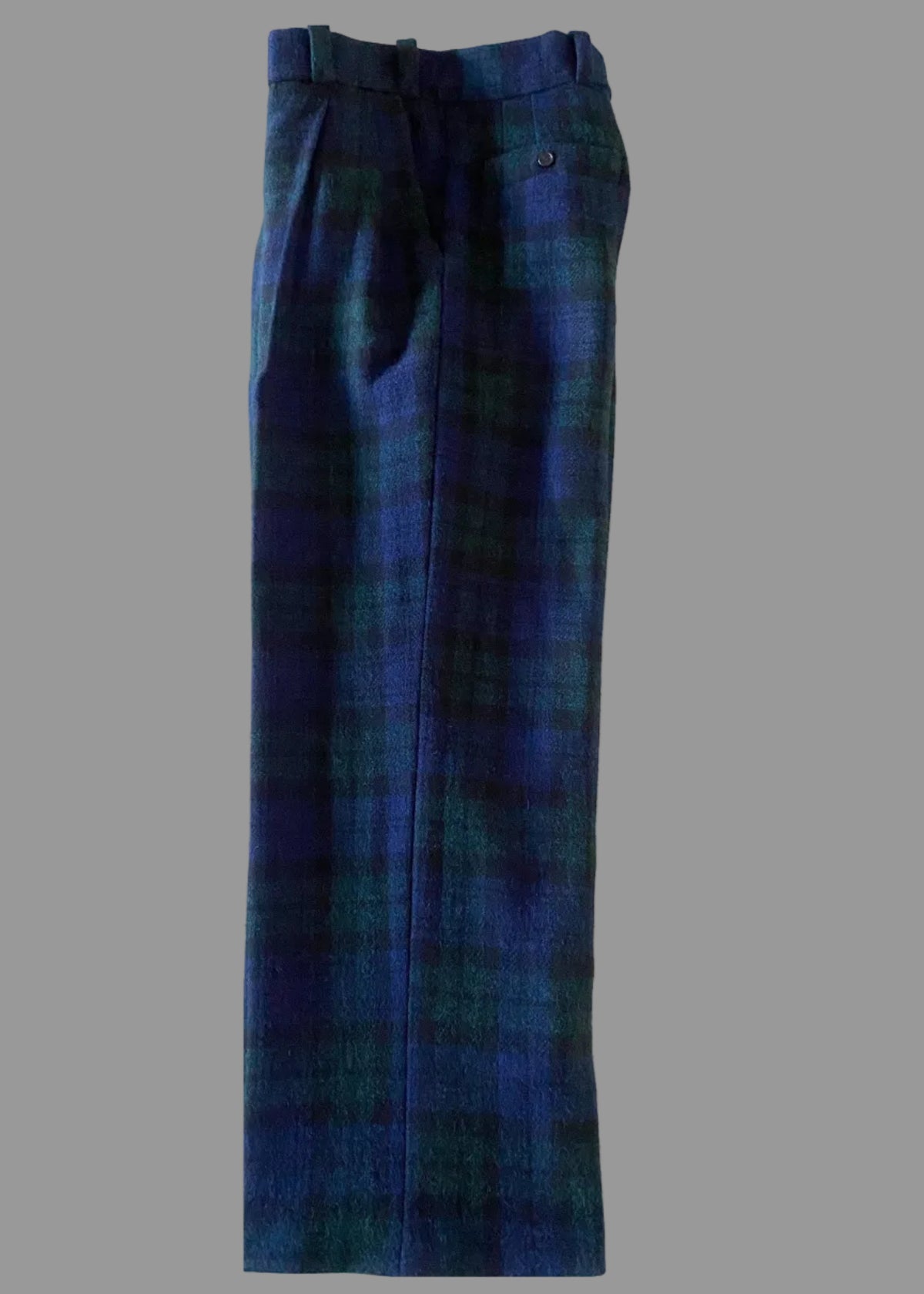 Stacy Stewart Smith's Blackwatch Plaid Harris Tweed® Reality Pants side view flat on a gray surface.