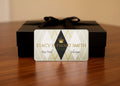 Stacy Stewart Smith gift card in a decorative box on a wooden surface