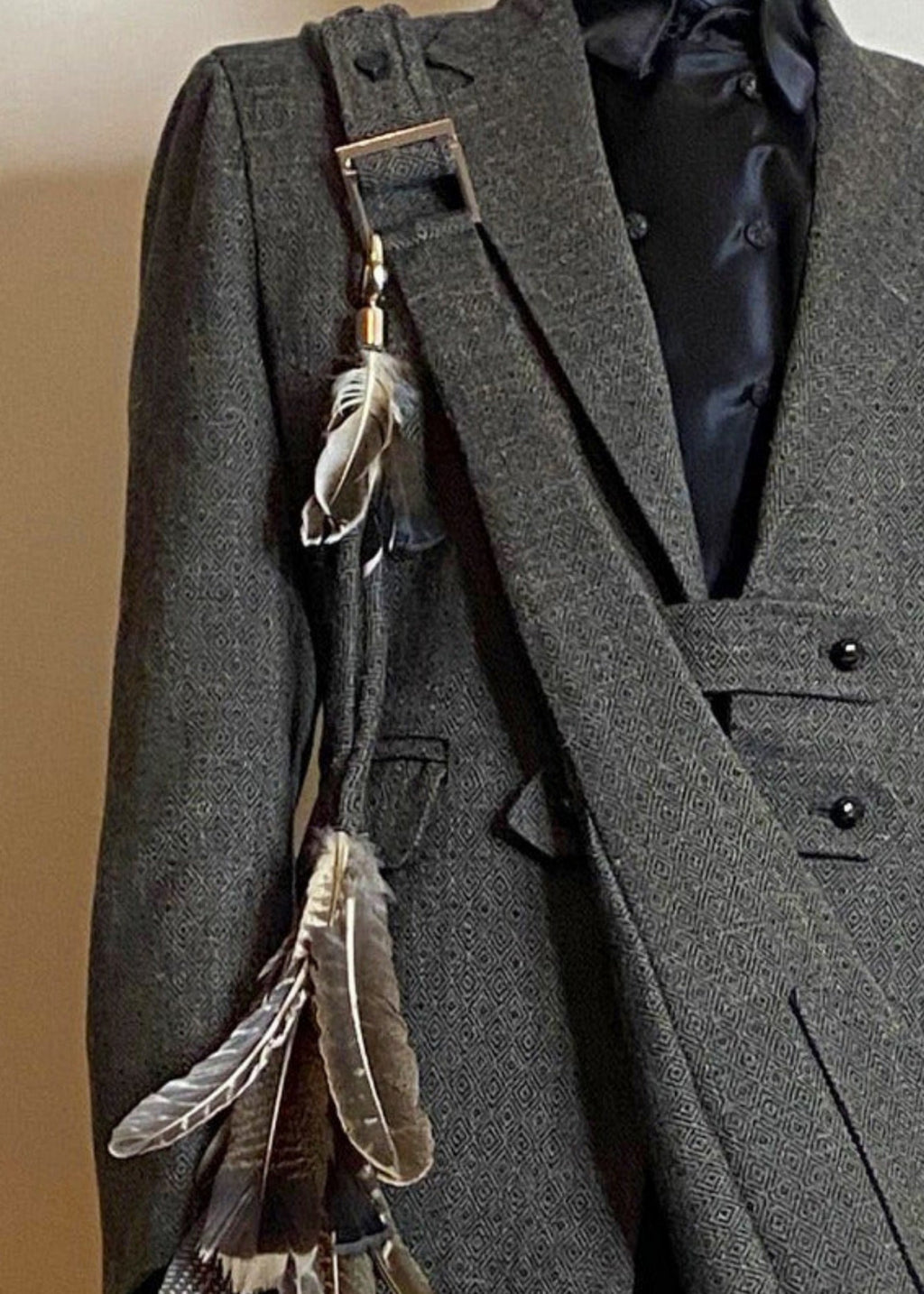 Stacy Stewart Smith Men's Diamond Dodger Tweed Newsie Sling Bag on male model 6'3" wearing matching tweed suit in front of an an Ivory wall. 