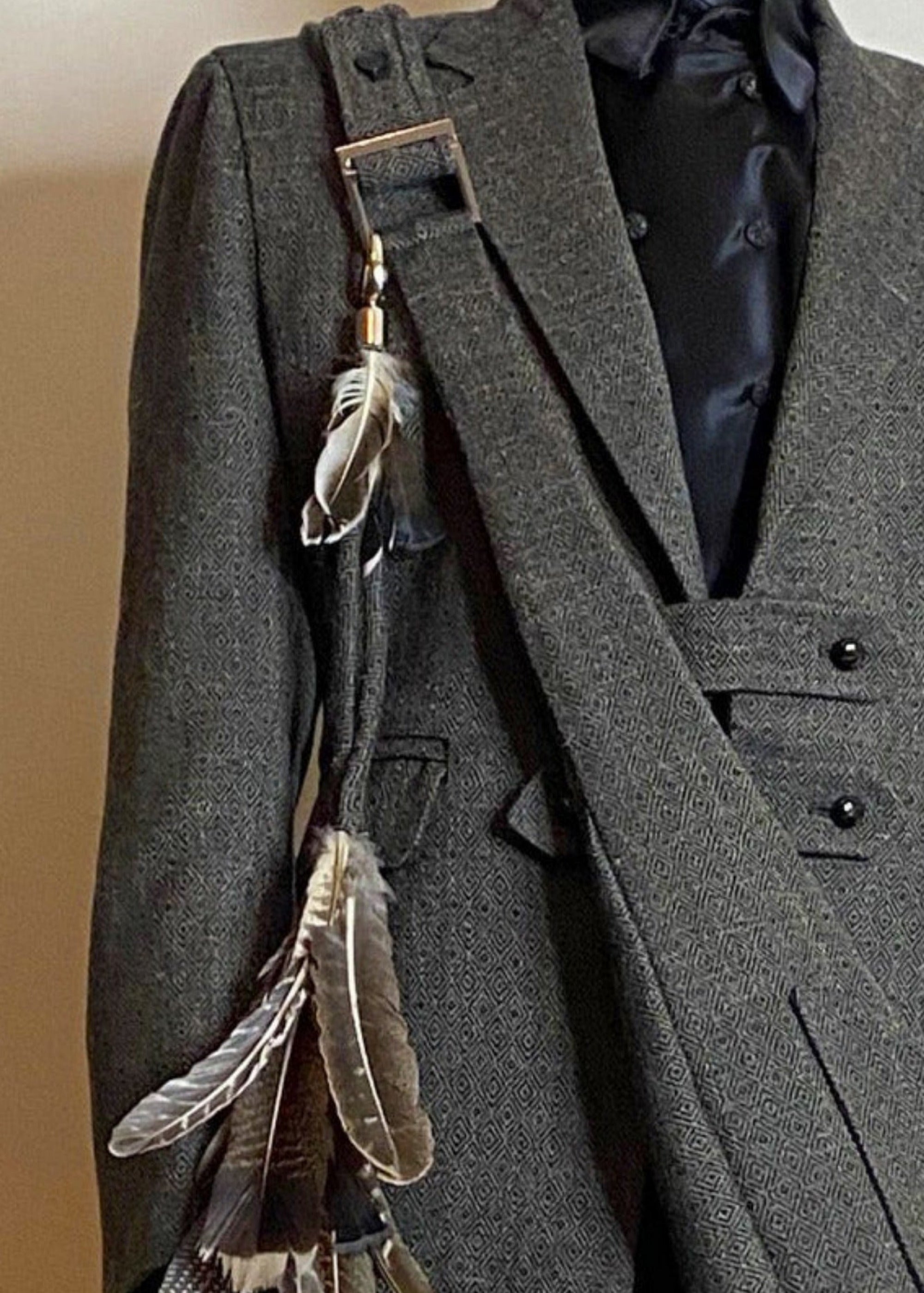 Stacy Stewart Smith Men's Diamond Dodger Tweed Newsie Sling Bag on male model 6'3" wearing matching tweed suit in front of an an Ivory wall. 
