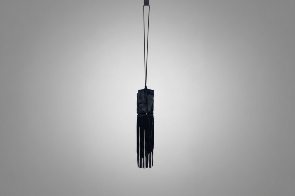 Stacy Stewart Smith Hair-On Calf Fringed Hope Wallet front landscape view hanging from a hook with white background.