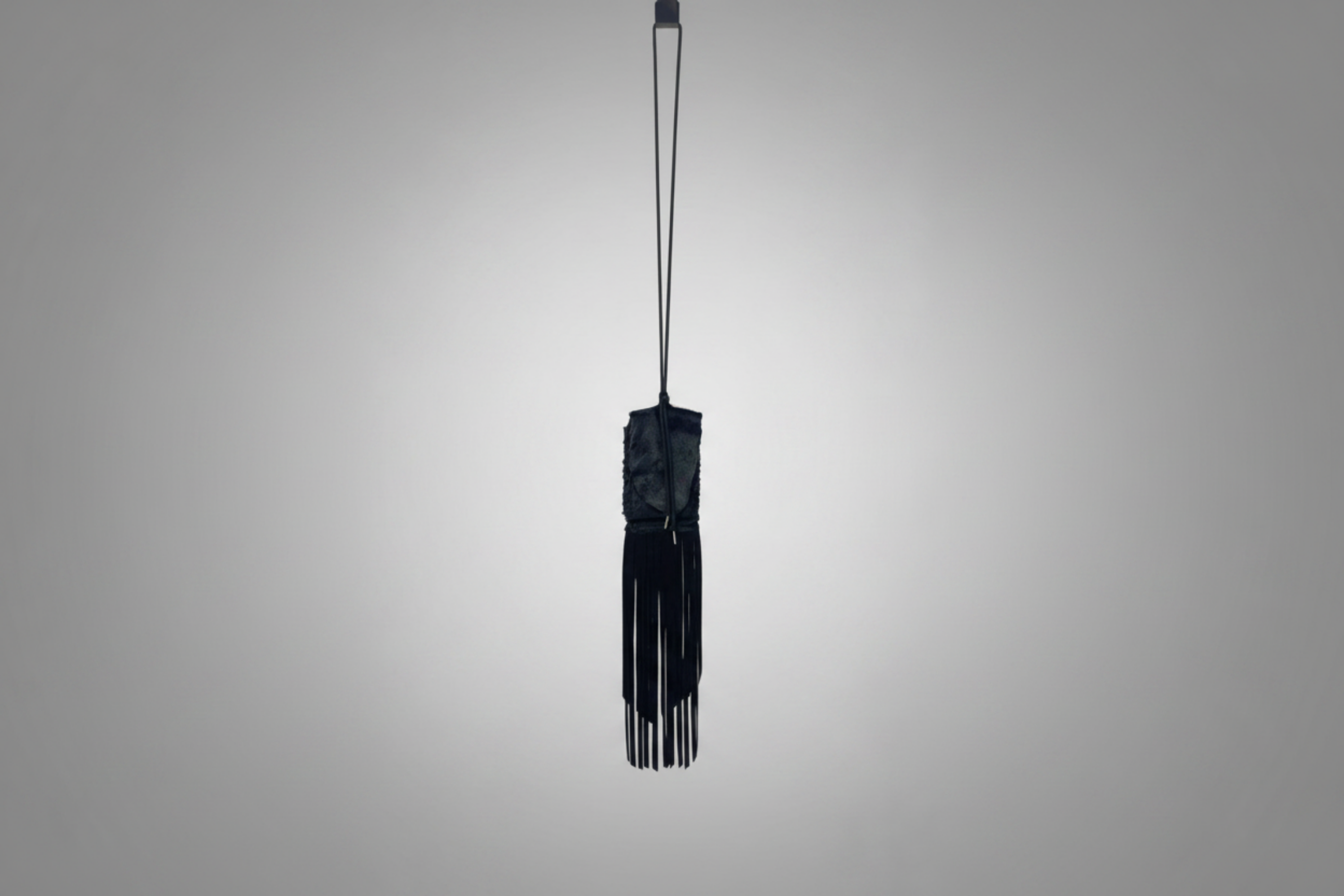 Stacy Stewart Smith Hair-On Calf Fringed Hope Wallet front landscape view hanging from a hook with white background.