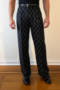 Stacy Stewart Smith Men's Ogee Embroidered Raw Silk Pleated Windsor Pants on a mannequin 6'3" front view pants in a room with a wooden floor and antique white wall.