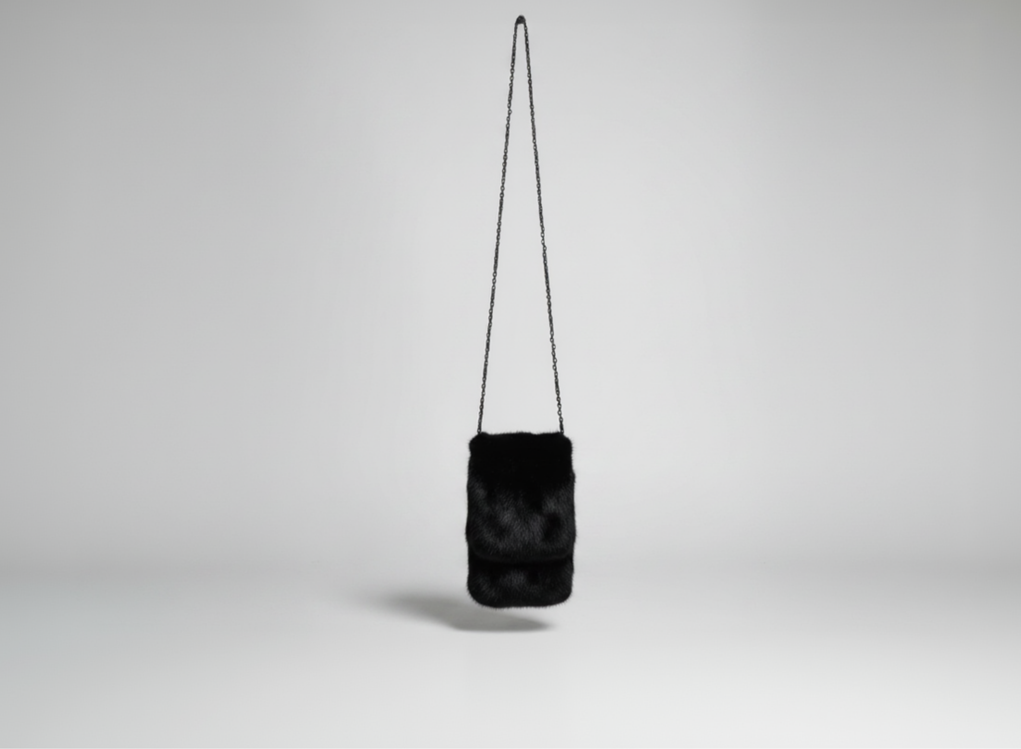 Stacy Stewart Smith Men's Black Gamma mink Sporran Pocket Bag landscape front view hanging with gray backdrop.