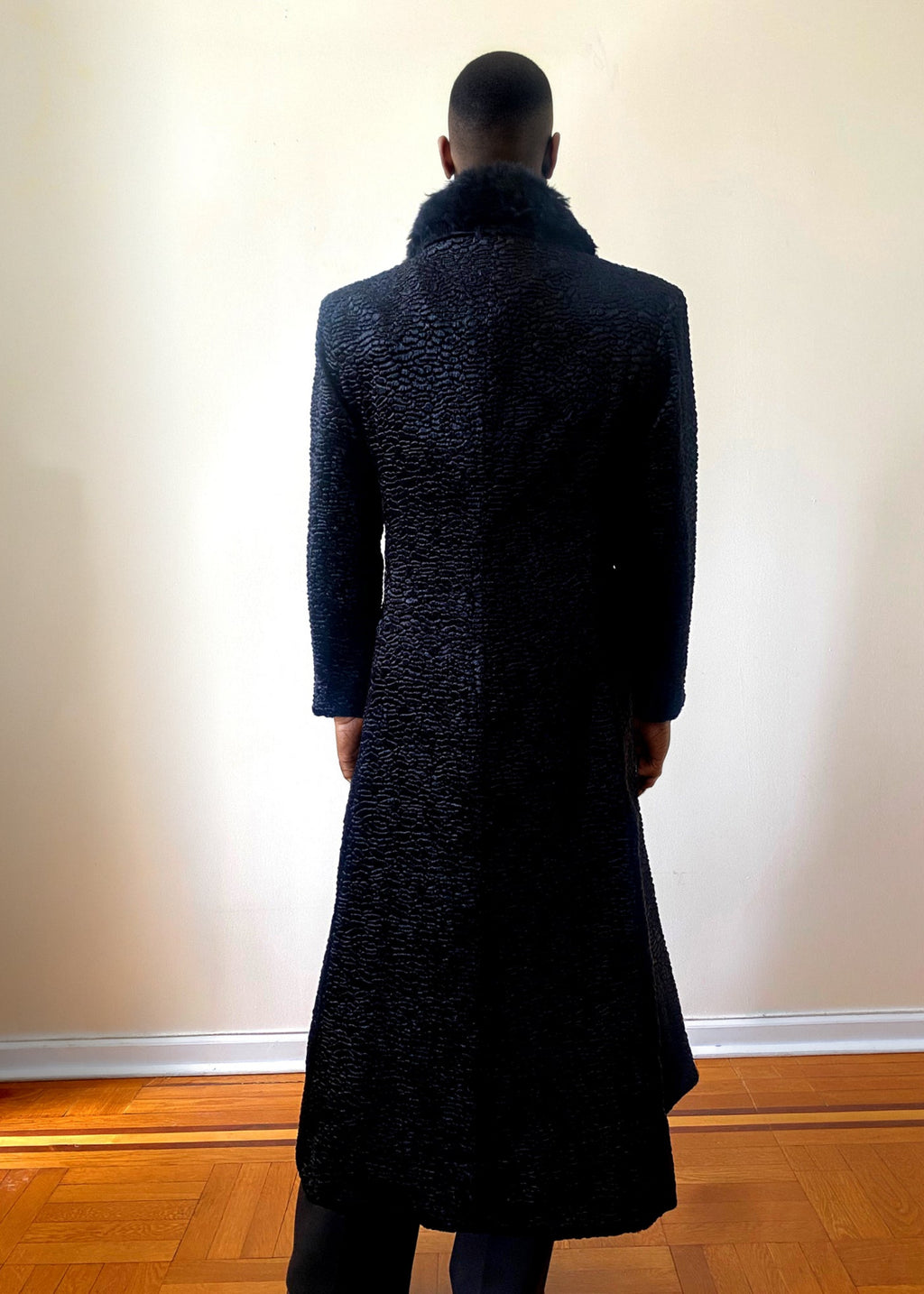 Stacy Stewart Smith Night Watchman Faux Persian Lamb Coat in Coal Black, shown on mannequin at 6'3