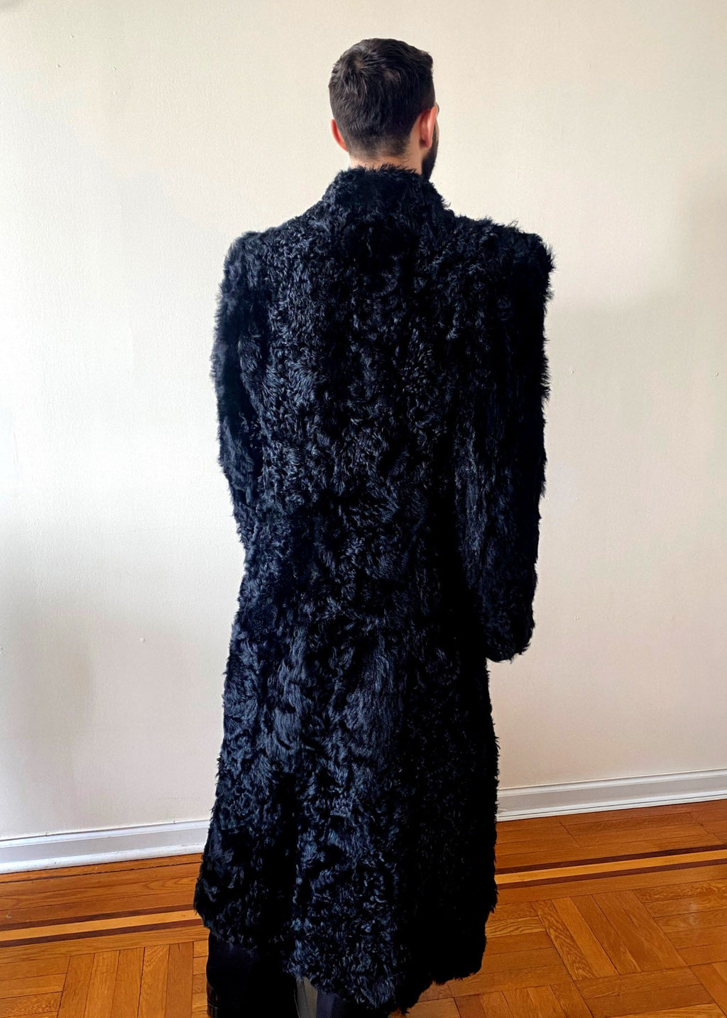 Stacy Stewart Smith Men's Bishop Long Black Curly Lamb Shearling Coat on mannequin standing 6'3" back view.