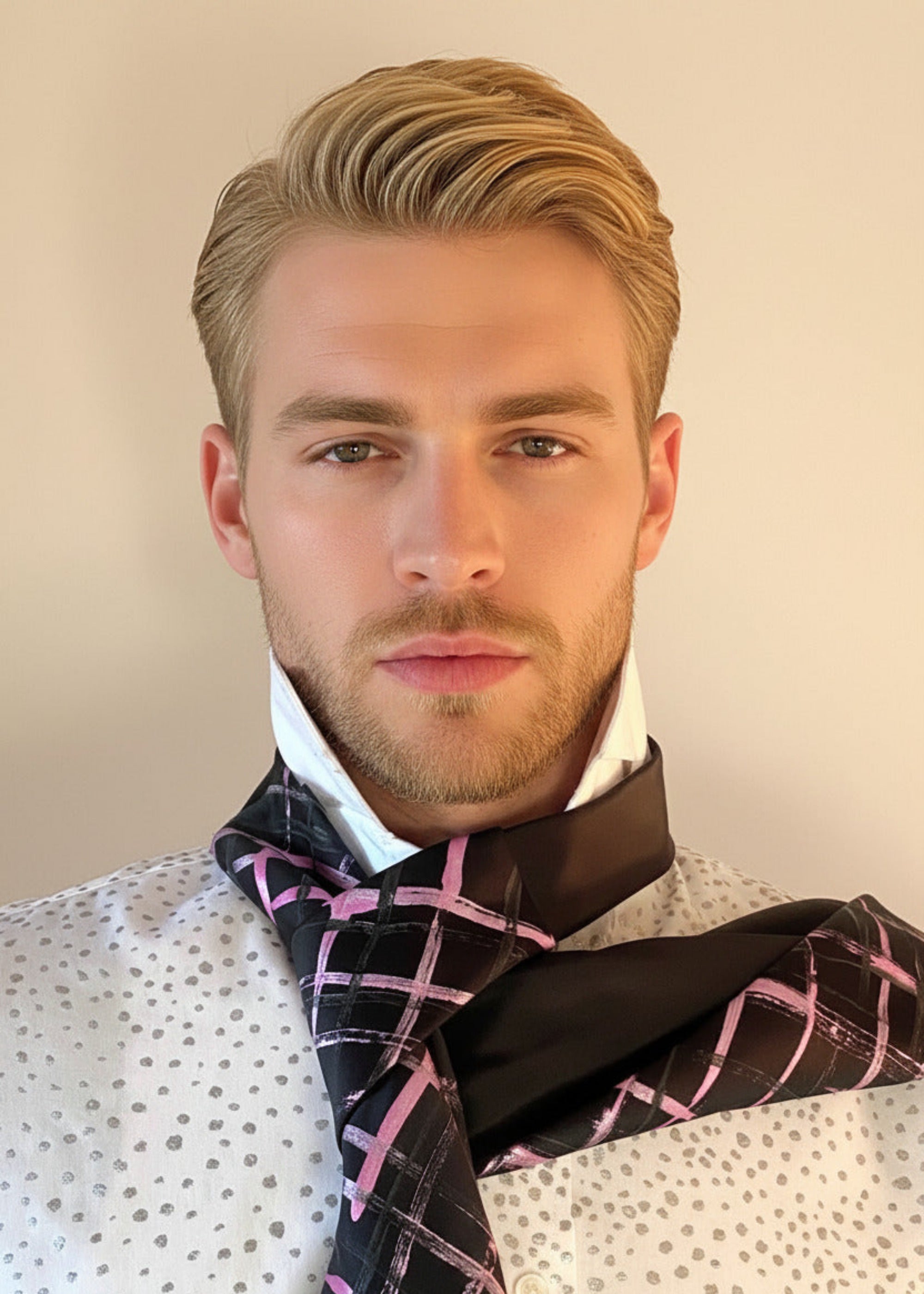 HOW TO TIE A CRAVAT: STEP 3 Atelier Quarterly presents Stacy Stewart Smith's Hand-Painted Cotton Percale Shirt and Hand-Painted Silk Cravat in Onyx/Shocking on a male mannequin front view with collar up against an ivory backdrop.
