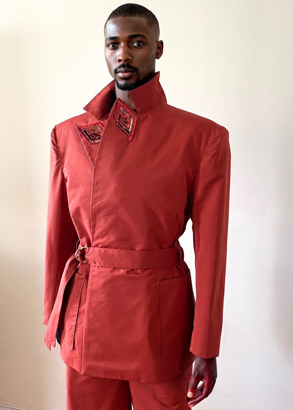 Sky & Ruby Trench-Jack persimmon front view collar up on a mannequin 6'3" in front of an antique white wall.