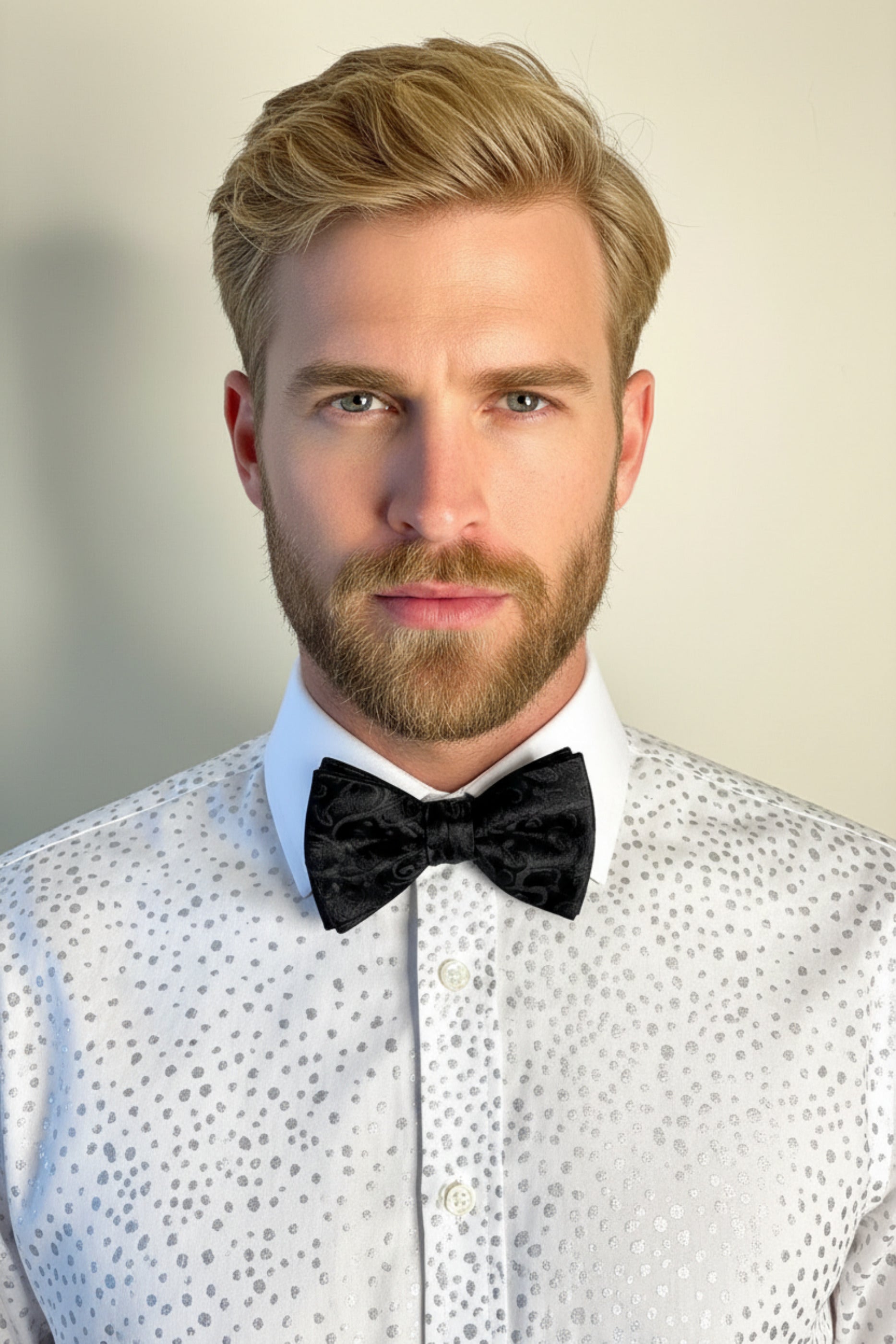 Mannequin wearing a hand-painted shirt with a black arabesque hand-painted bow tie, both by Stacy Stewart Smith, against a neutral background