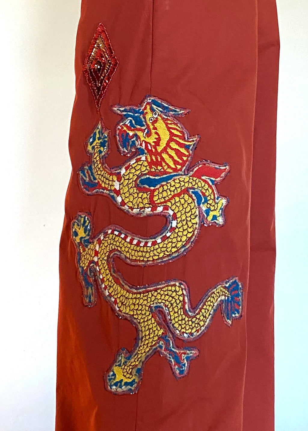 Stacy Stewart Smith Dragon & Ruby Flat Front Persimmon Cotton Twill Windsor Pants on a mannequin 6'3" closeup left side view.