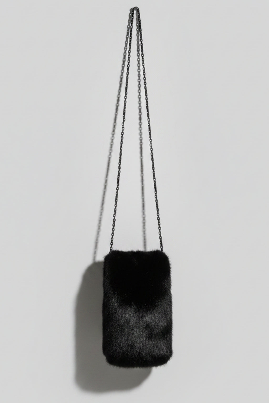 Stacy Stewart Smith Men's Black Gamma mink Sporran Pocket Bag back view hanging with gray backdrop.