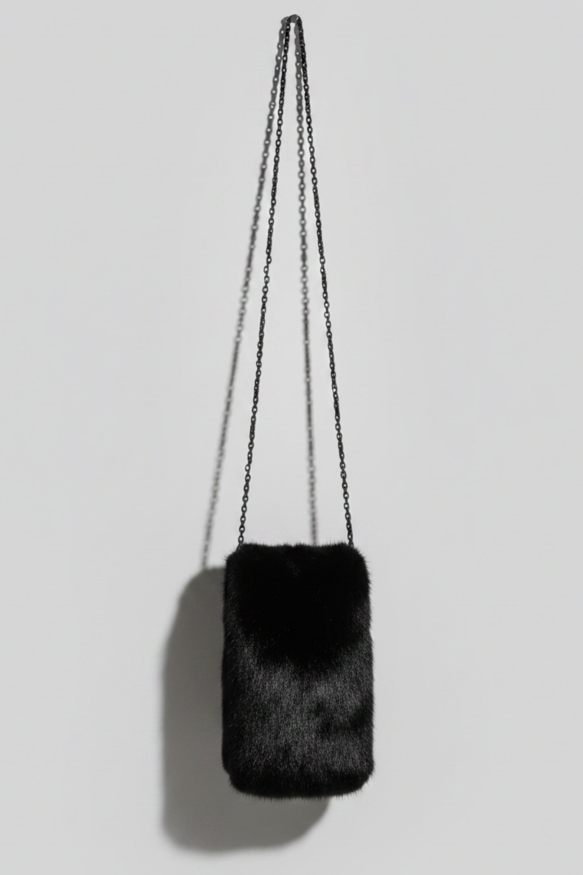 Stacy Stewart Smith Men's Black Gamma mink Sporran Pocket Bag back view hanging with gray backdrop.