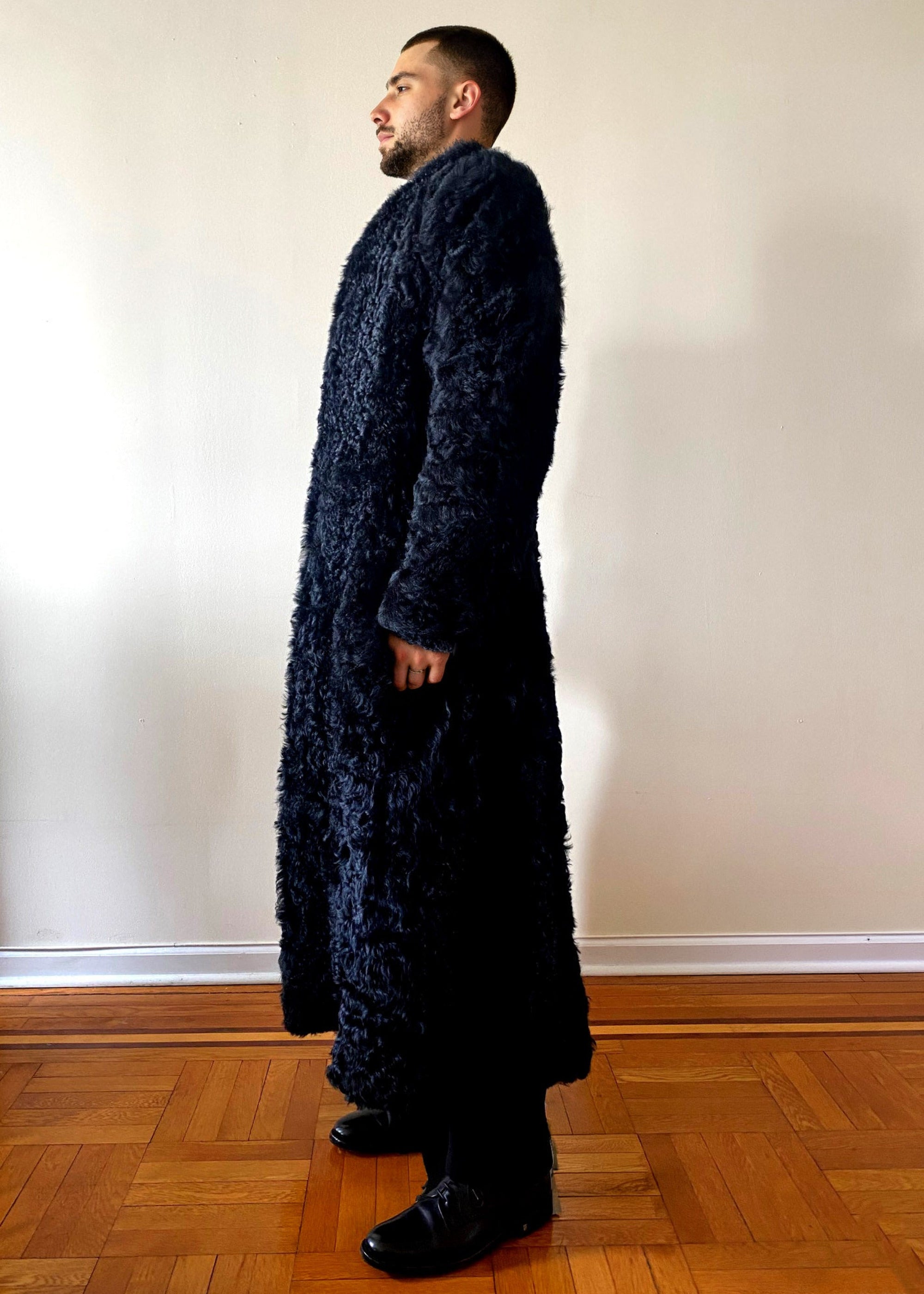 Stacy Stewart Smith Men's Bishop Long Black Curly Lamb Shearling Coat on mannequin standing 6'3" left side view