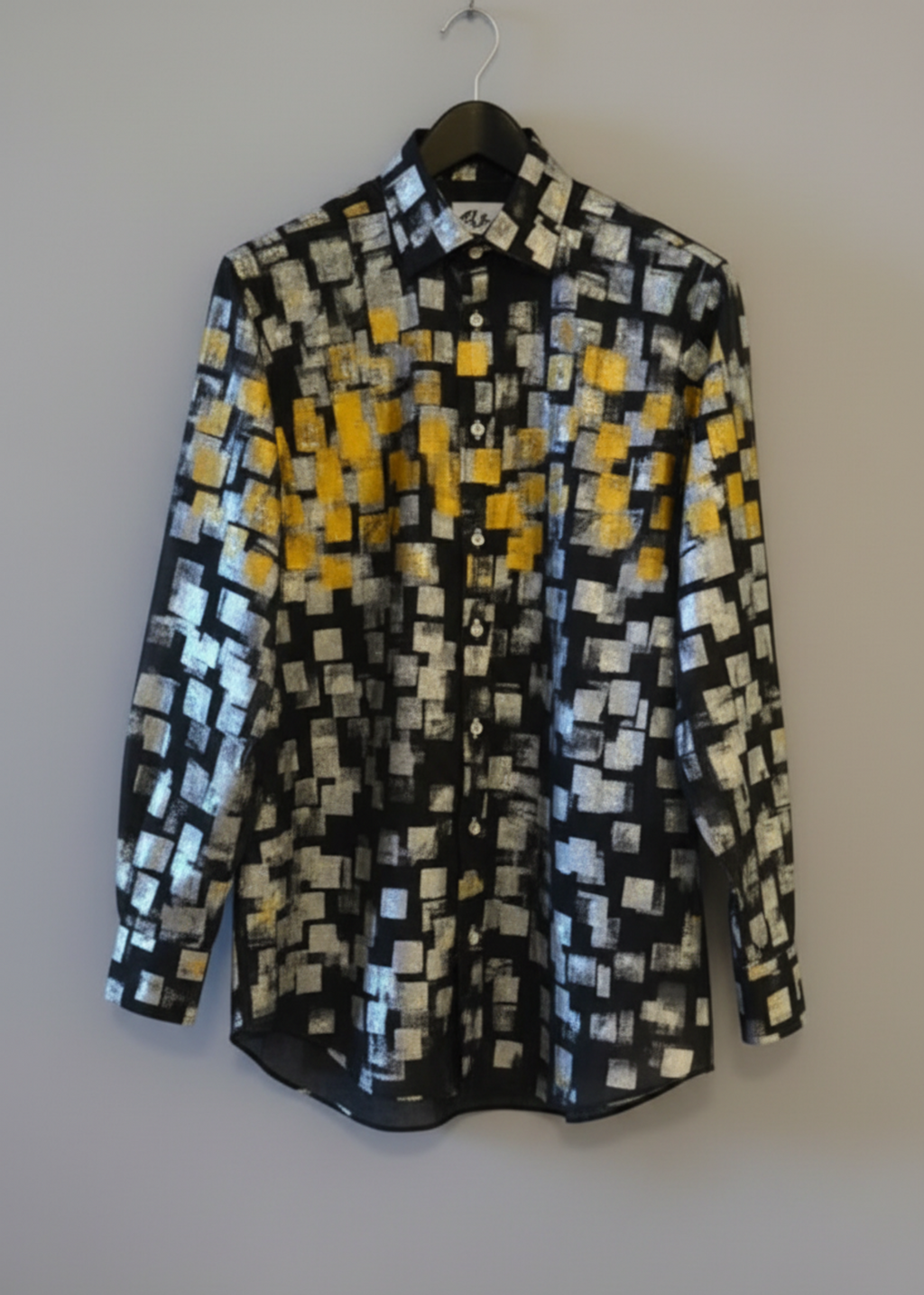 Stacy Stewart Smith Men's Black Premium Cotton Percale Hand-Painted Gold & Silver Pixels Shirt front view on a hanger with gray background. 