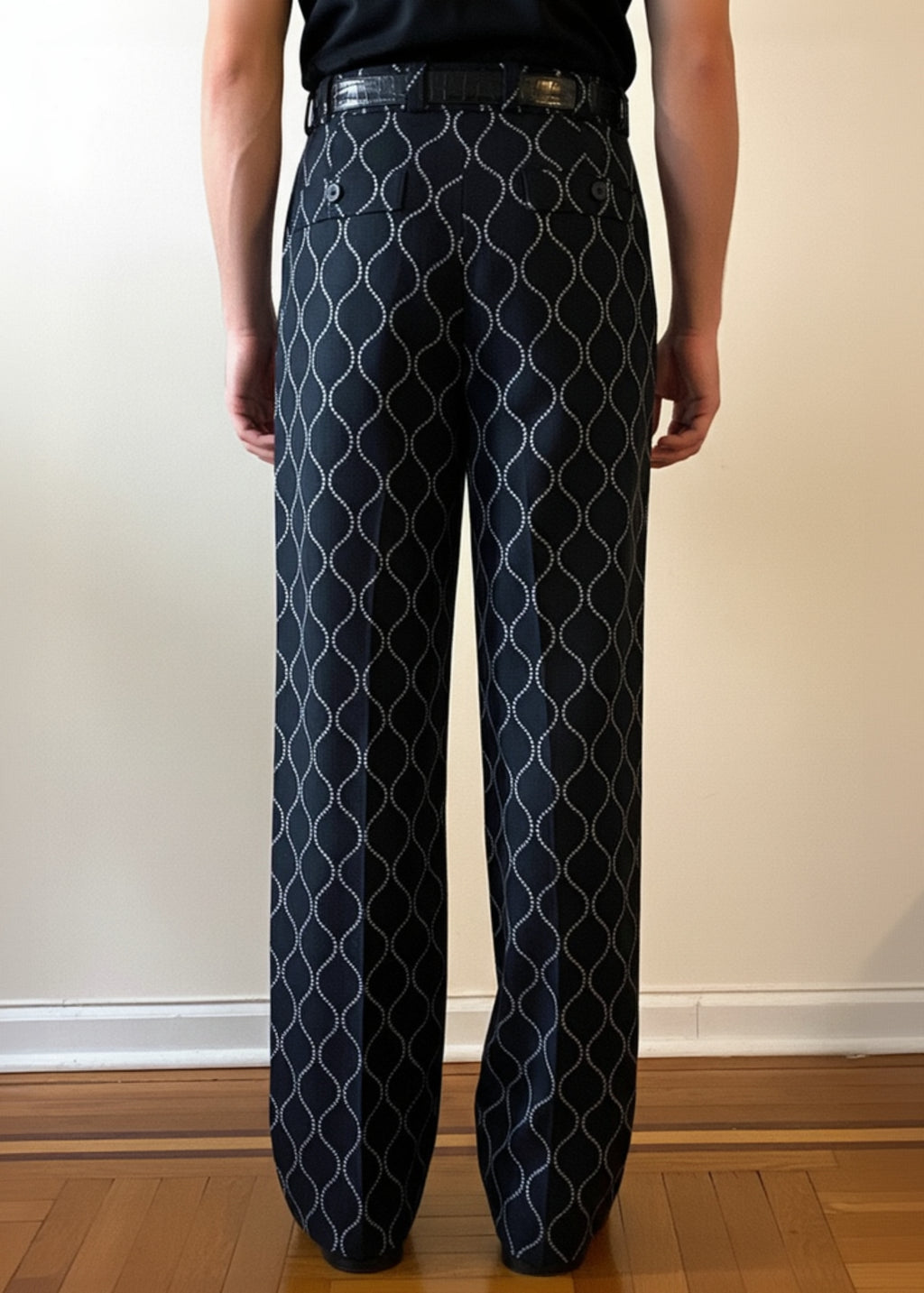 Stacy Stewart Smith Men's Ogee Embroidered Raw Silk Pleated Windsor Pants on a mannequin 6'3" back view pants only in a room with a wooden floor and antique white wall.