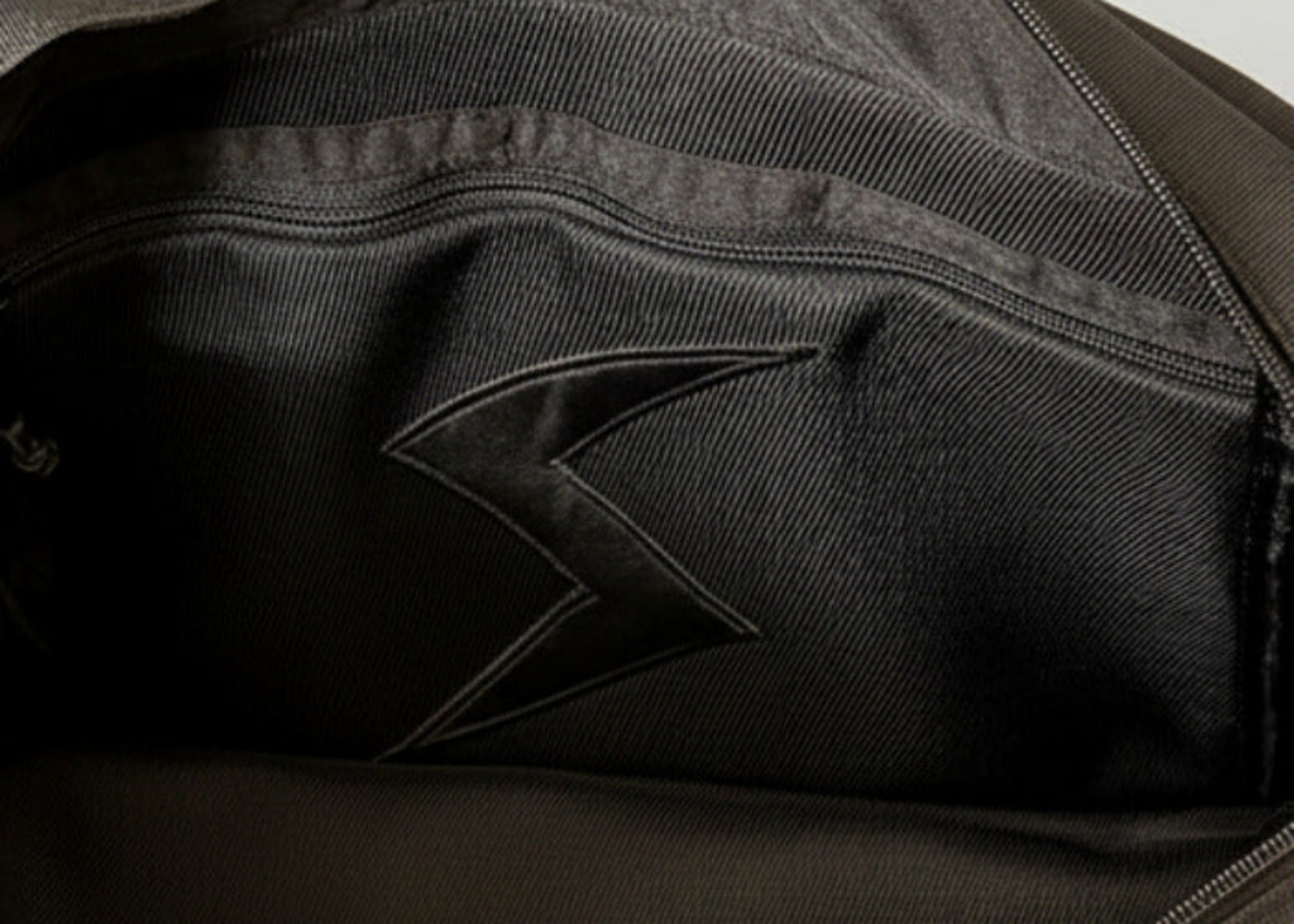 Stacy Stewart Smith Trapezoid Leather Messenger Bag in Onyx view of lining zip pocket and S logo applique pocket Stacy Couture brand label.