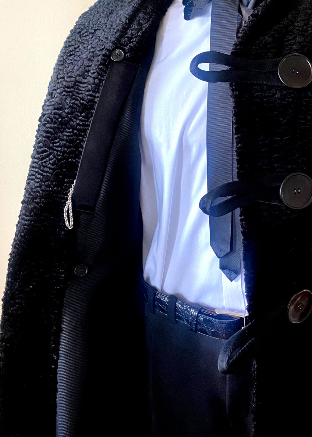 Stacy Stewart Smith Night Watchman Faux Persian Lamb Coat in Coal Black, shown on mannequin at 6'3
