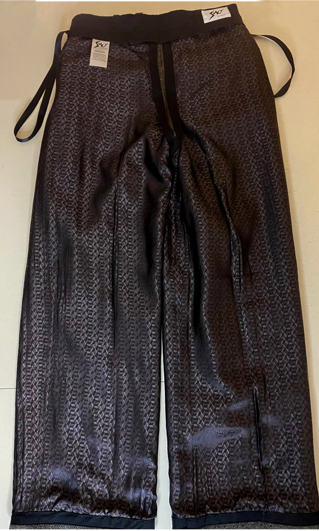 Stacy Stewart Smith Men's Highland Gentry Diamond Tweed Suit back full flat view of the pants boxed lining, hanging ribbon on an Ivory surface.brand labels on an Ivory surface.