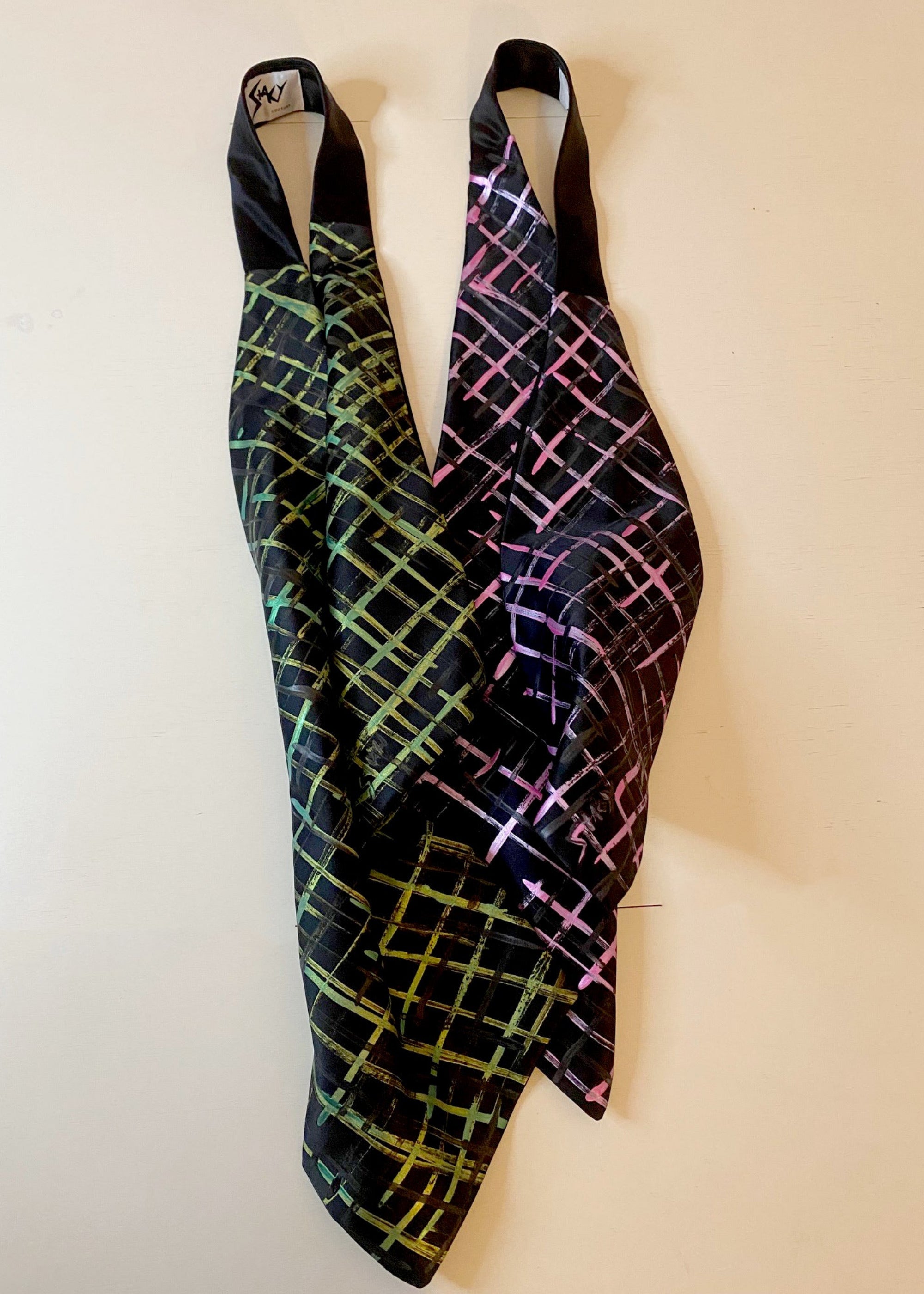 Stacy Stewart Smith two Silk Satin Crosshatch Cravat in Shocking Pink and Peridot on black with white shirt on an gray surface.