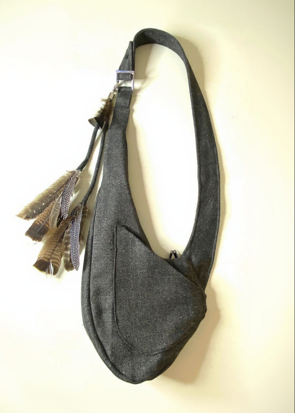 Stacy Stewart Smith Men's Diamond Dodger Tweed Newsie Sling Bag on an Ivory Surface front view.