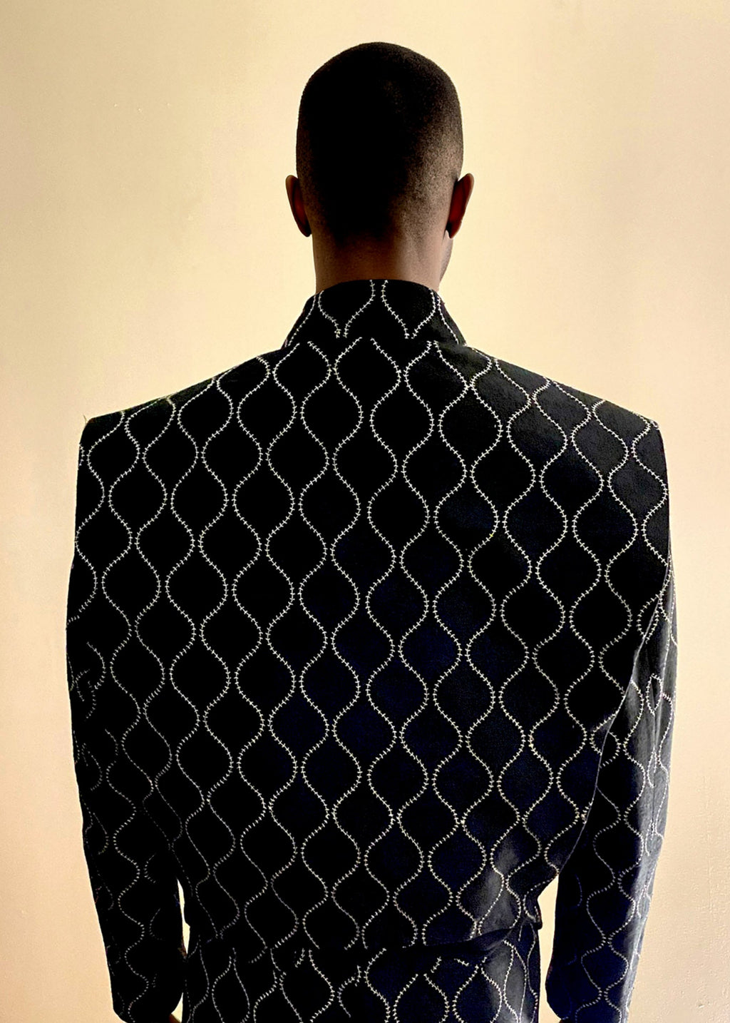 Stacy Stewart Smith Ogee Embroidered Raw Silk Flange-Back Moto Jacket on a mannequin 6'3" back view and antique white background.