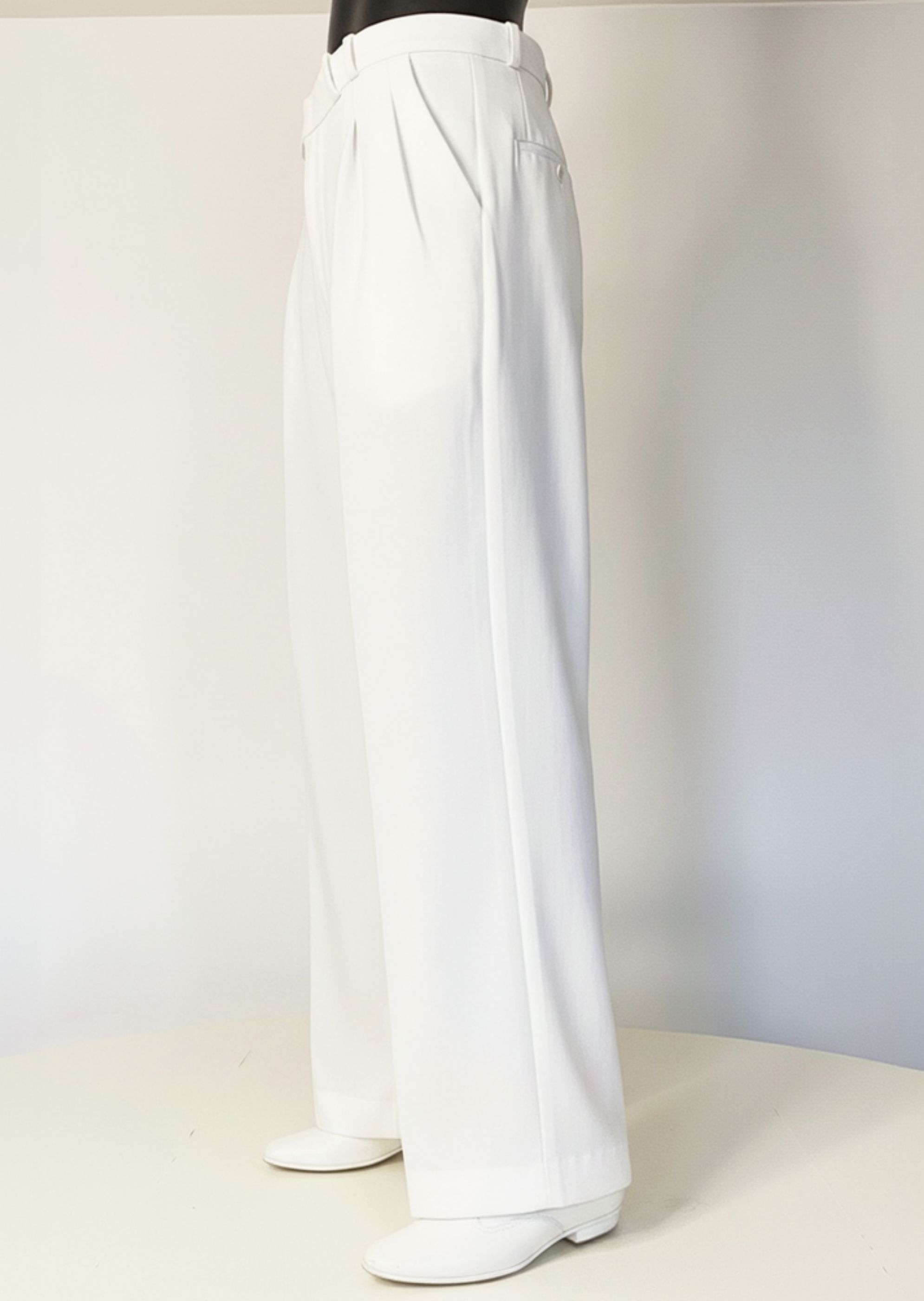 Stacy Stewart Smith Men's White Knit Pleated Windsor Pants 3/4 view on mannequin 6'3" with ivory backdrop. 