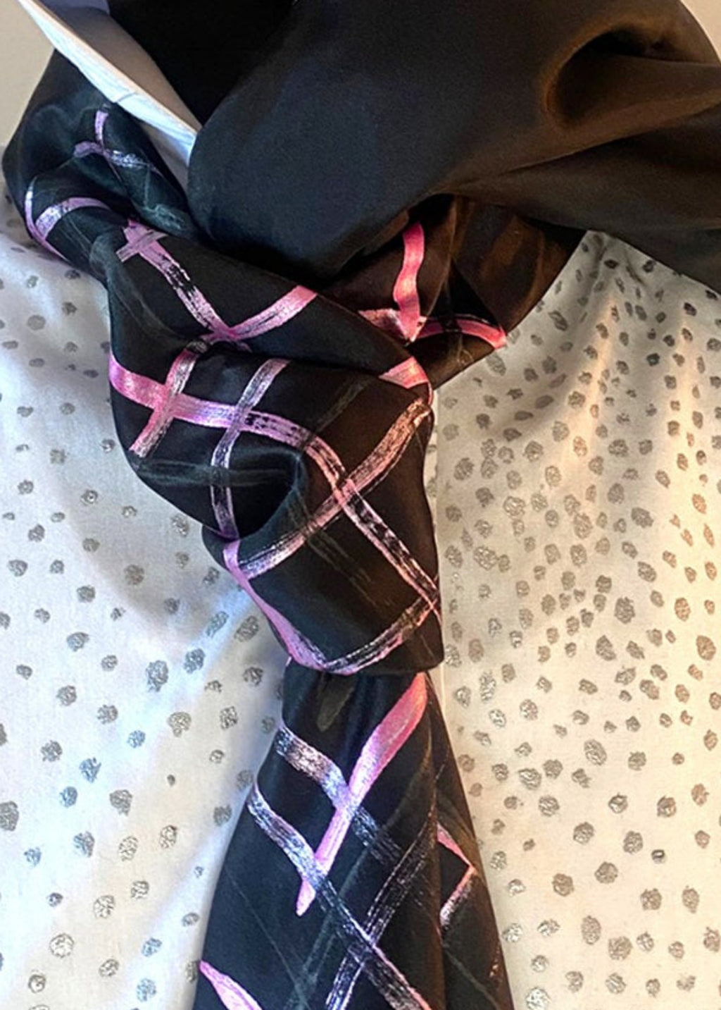 HOW TO TIE A CRAVAT: STEP 6 Atelier Quarterly presents Stacy Stewart Smith's Hand-Painted Cotton Percale Shirt and Hand-Painted Silk Cravat in Onyx/Shocking on a male mannequin front view with collar up against an ivory backdrop.
