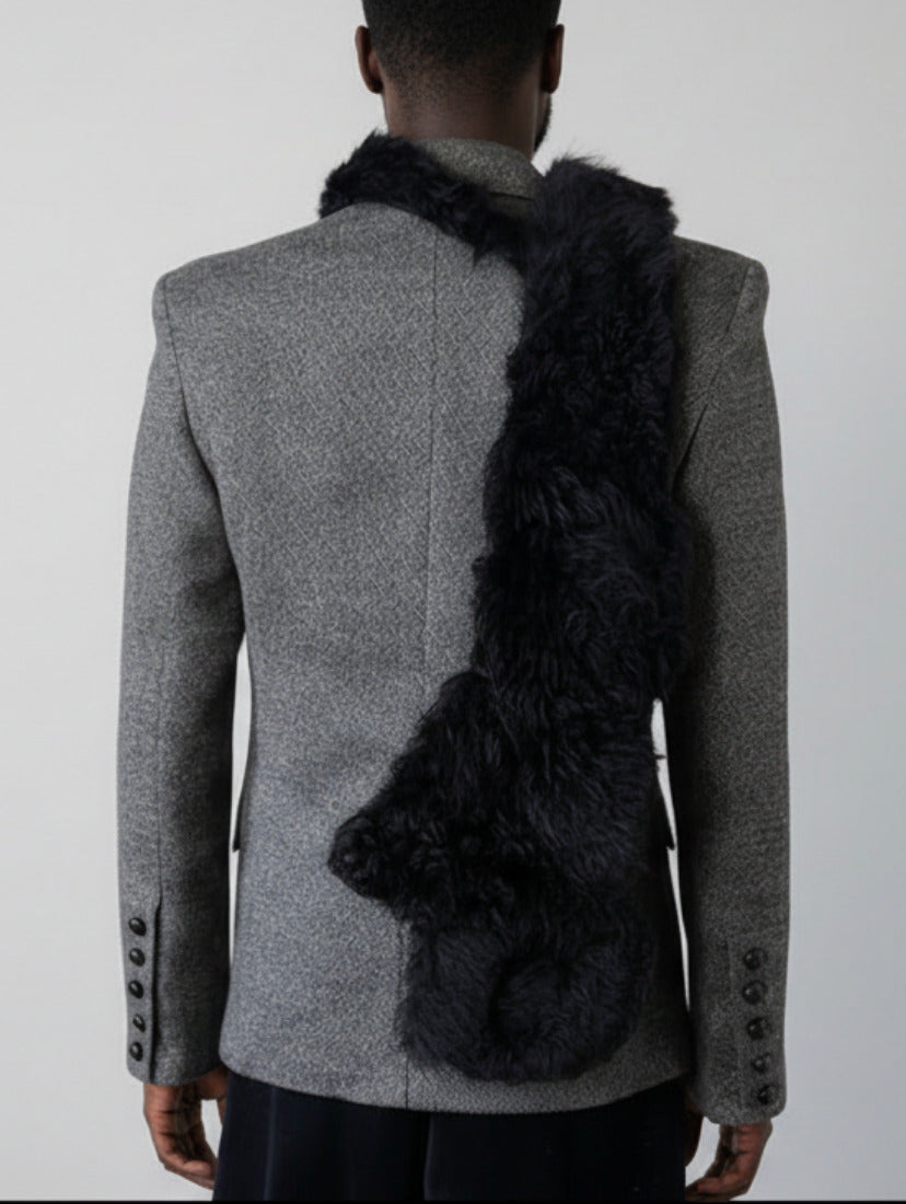 Stacy Stewart Smith Black Shearling & Leather Coil Scarf fur side on mannequin wearing a Stacy menswear Couture suit jacket back view.