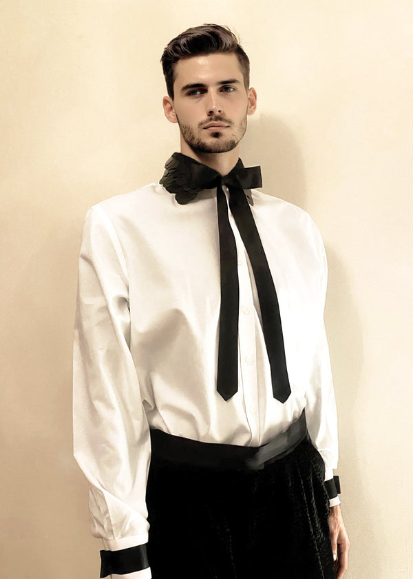 Stacy Stewart Smith Men's Leviathan Scales Western Tuxedo Shirt front view with bow against antique white wall. 
