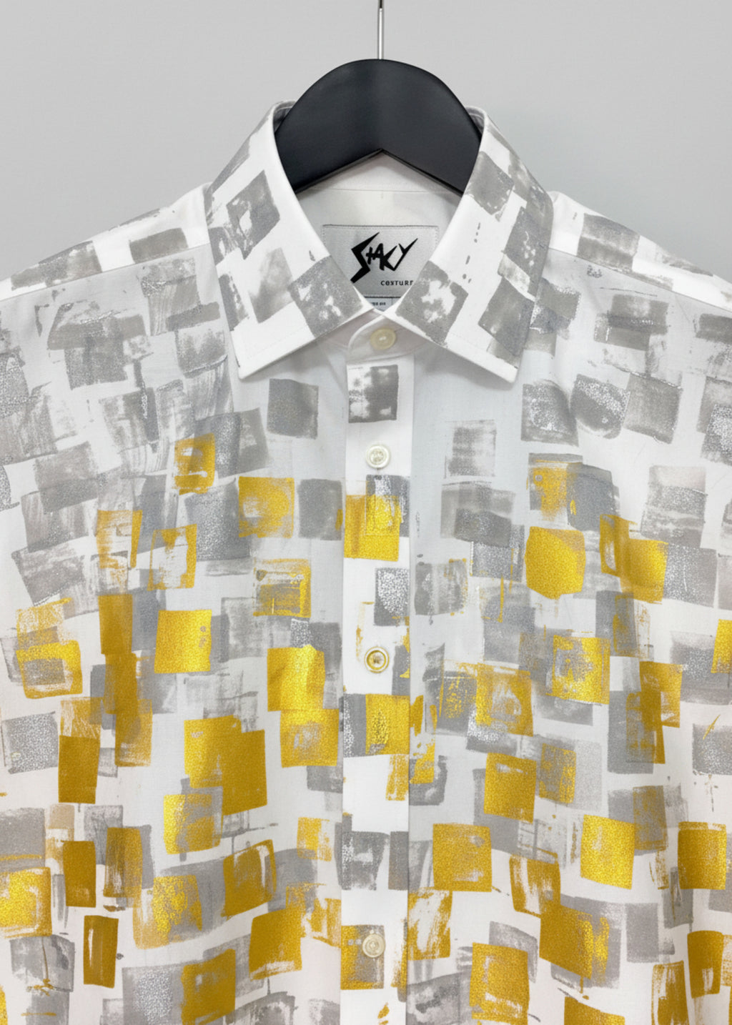 Stacy Stewart Smith Men's White Premium Cotton Percale Hand-Painted Gold & Silver Pixels Shirt on a hanger zoomed neckline view with white veil curtain backdrop