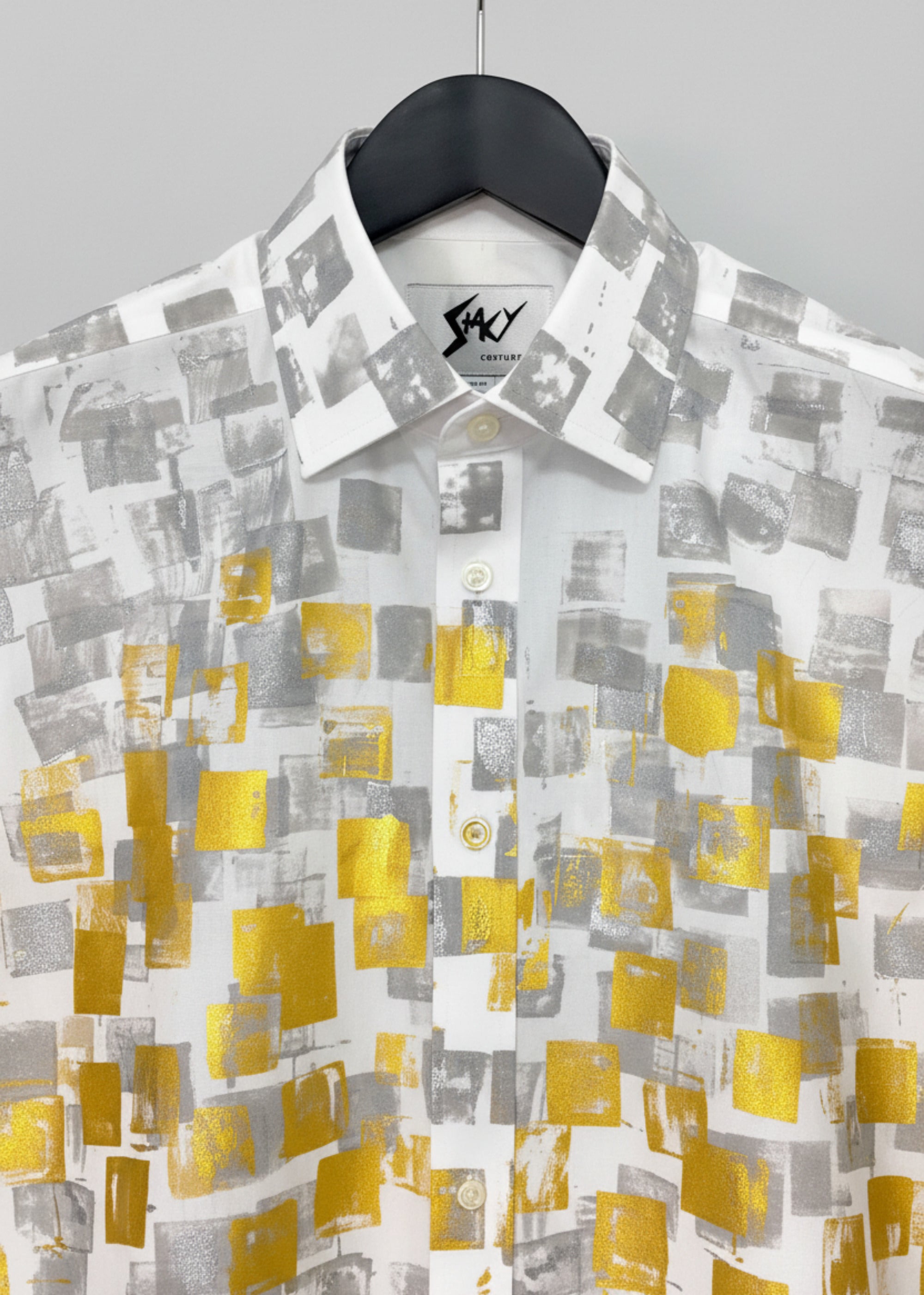 Stacy Stewart Smith Men's White Premium Cotton Percale Hand-Painted Gold & Silver Pixels Shirt on a hanger zoomed neckline view with white veil curtain backdrop